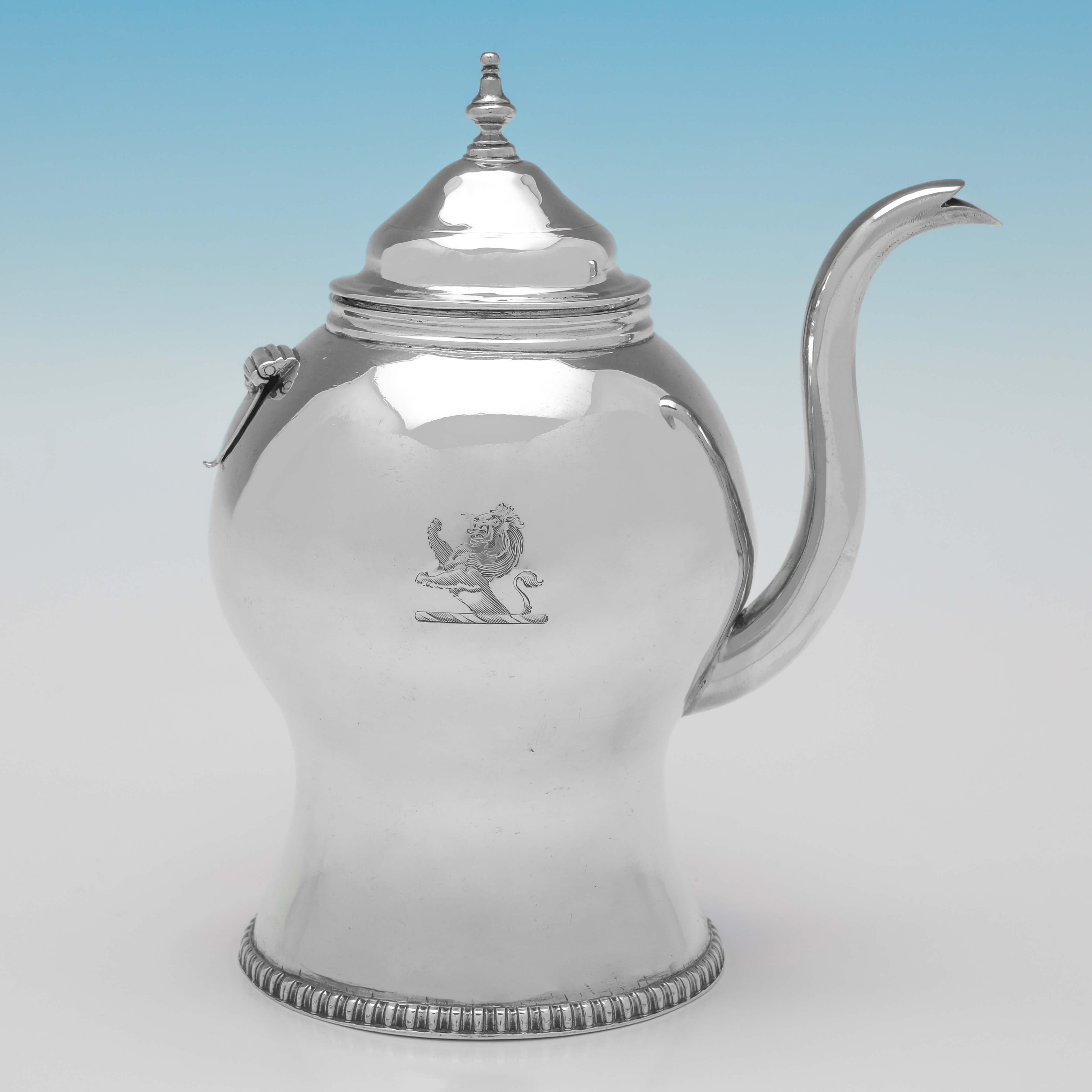 Hallmarked in London in 1813 by Joseph Biggs, this charming George III, antique Sterling Silver Argyll, has a cylindrical body standing on a platform base, with a gadroon border and engraved crest. The handle has a wicker cover and the hot water