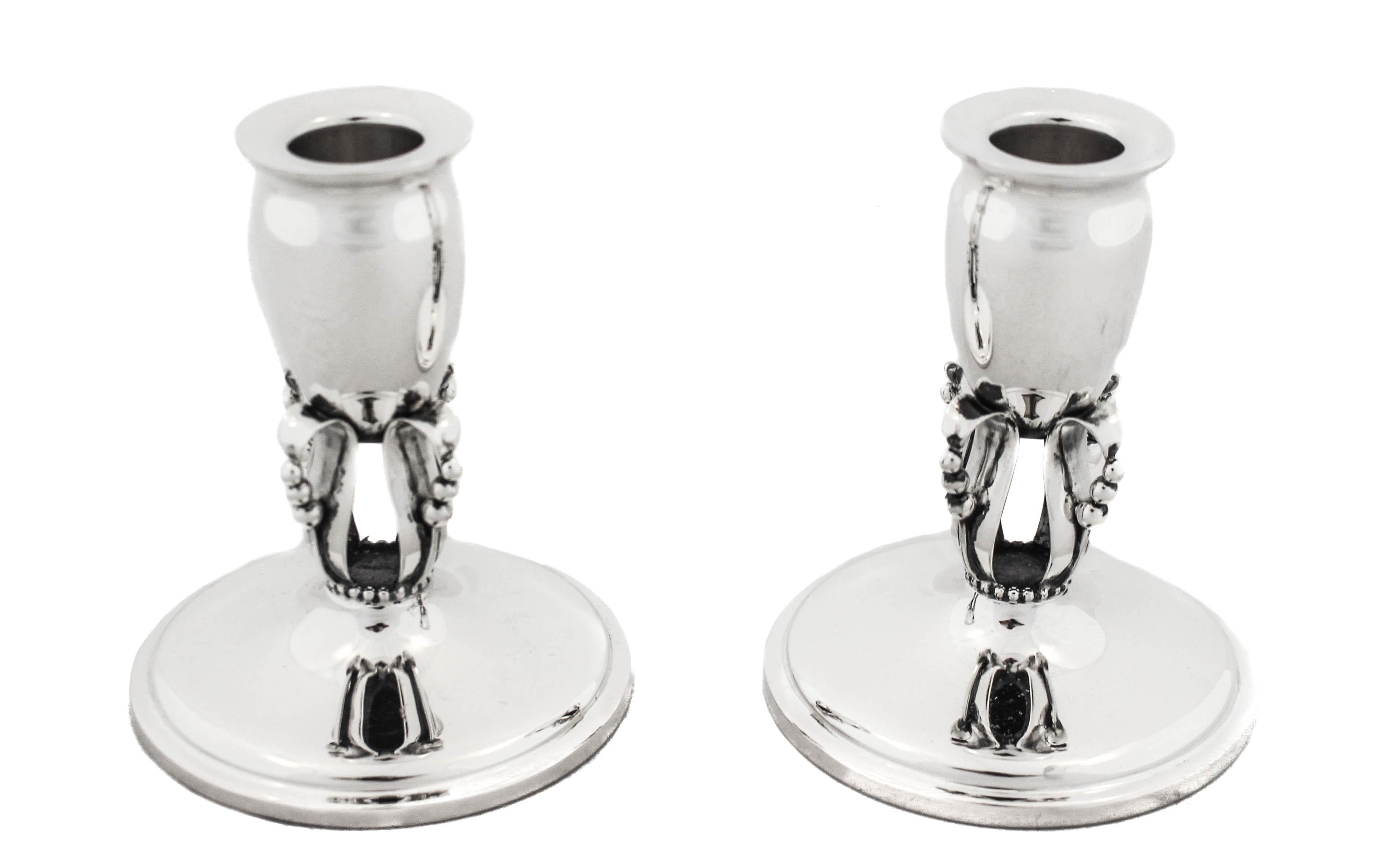 Being offered is a pair of sterling silver Art Deco candlesticks by Mueck Cary Silver.  If you love Art Deco these candlesticks are for you! Understated and elegant, they have a modern shape with four beaded rings beneath each holder.  They are not