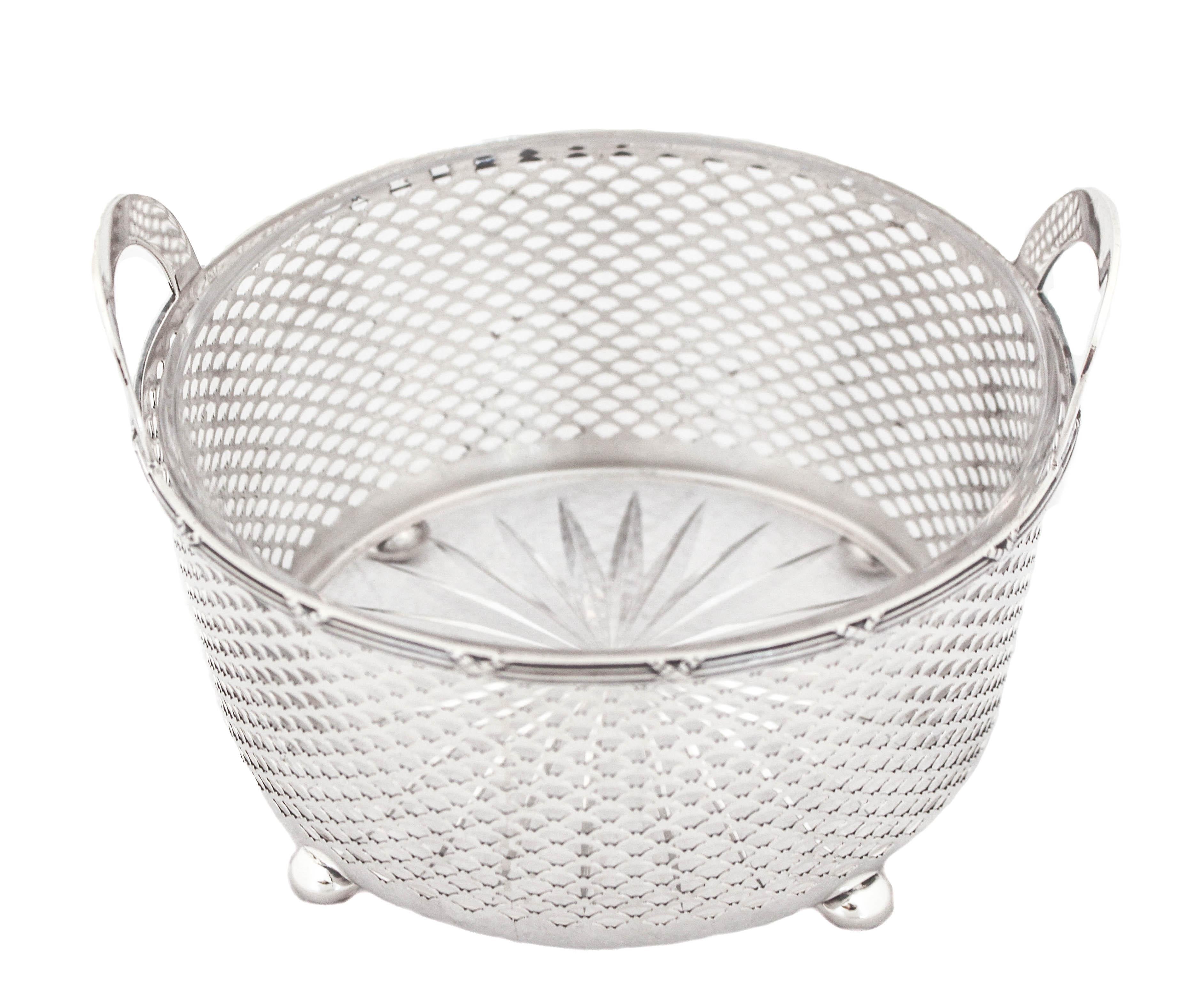 Being offered is a sterling silver Art Deco ice bucket by the Meriden Britannia Company. It stands on four balls and is raised off the surface.  It has arched cutout handles so it’s easy to carry and pass around.  The reticulated design around the