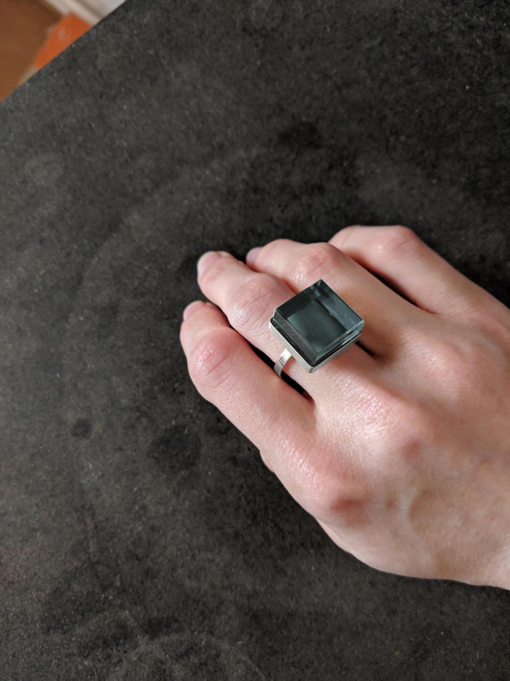 This sterling silver ring features a 15x15x8mm blue quartz, cut in an unusual open shape that allows light to shine through. Its art deco style is suitable for both men and women and has been featured in Harper's Bazaar and Vogue UA.

The ring's