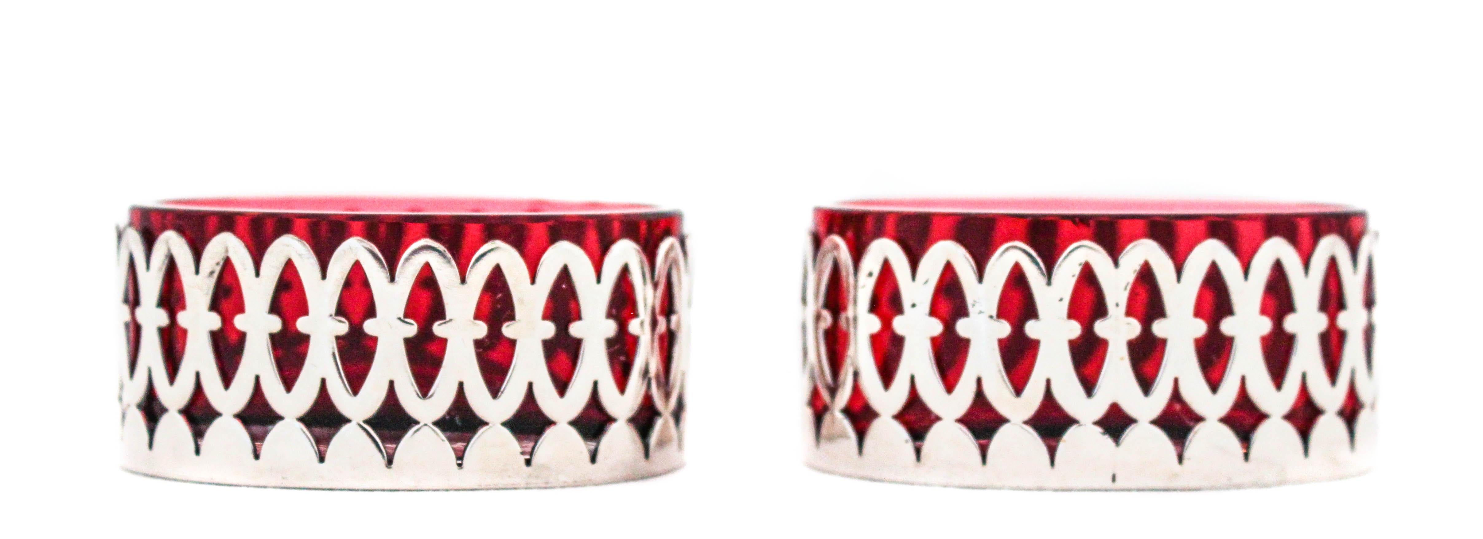 We are delighted to offer you this pair of Art Deco sterling silver salt cellars from the 1920s. Not only is it rare to find a pair of salt cellars but the Ruby red color and oval shape make this pair a triple-win!! The sterling silver encasement is