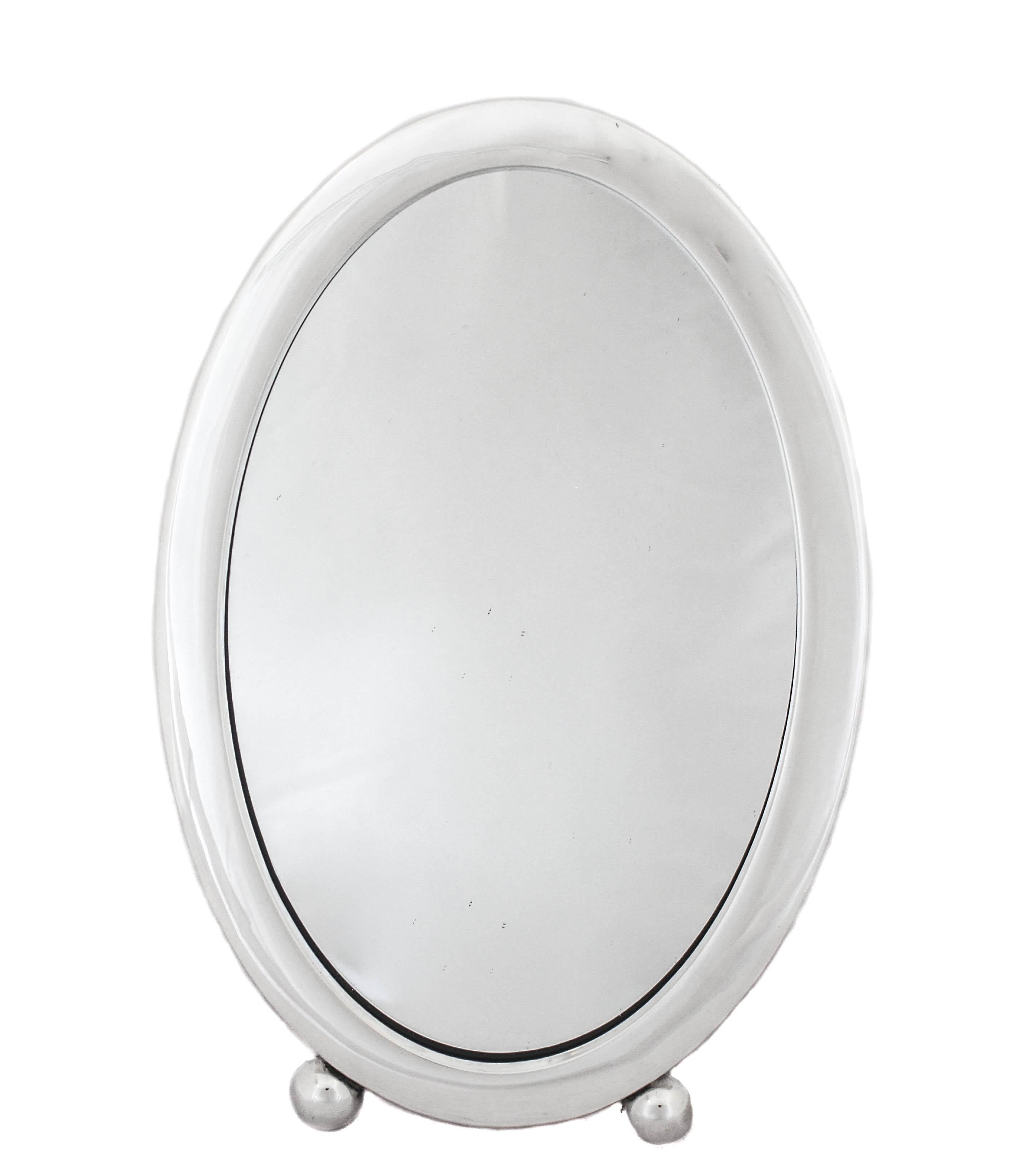 We are happy to offer you this sterling silver vanity mirror by J. F. Fradley & Company. It’s an uber-sleek table mirror that is contemporary and functional. It has two balls on the very bottom— an iconic Art Deco look that gives it an “edge”. The