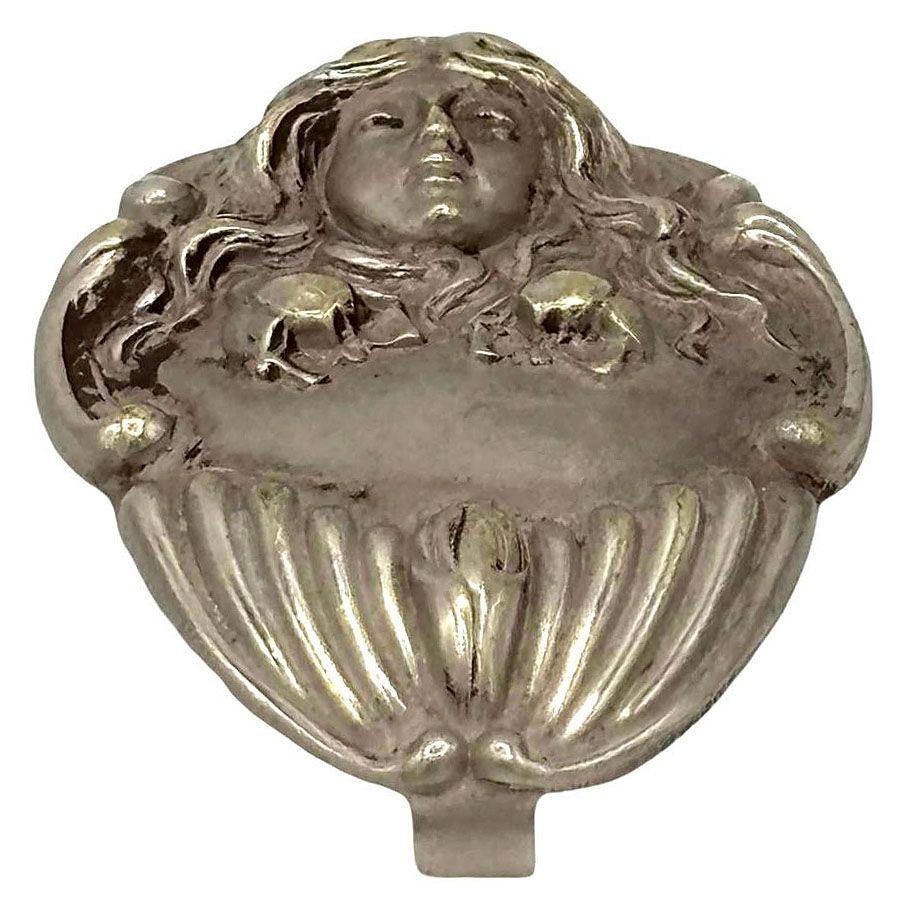 Turn of the century Art Nouveau Chatelaine Belt Clip features a delicate portrait of a female, framed by flowing, organic lines reminiscent of nature's elegance. Her serene expression is complemented by intricate details, including softly curling