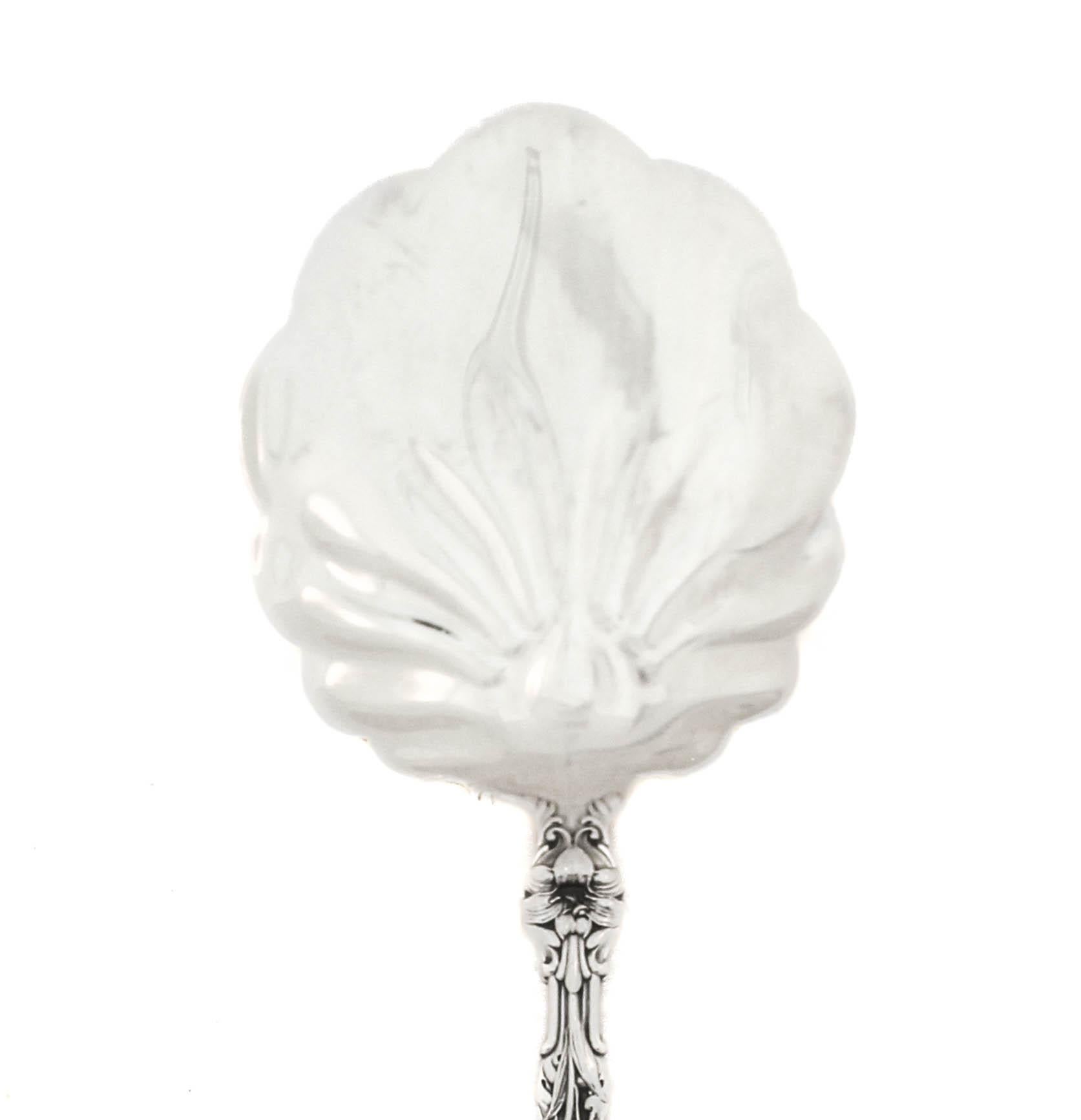 Being offered is a sterling silver serving piece by Gorham Silversmiths in the “Lily” pattern.  First introduced in 1910, “Lily” aka “Floral” quickly became a favorite among silver collectors.  Its Art Nouveau style was well received and Lily