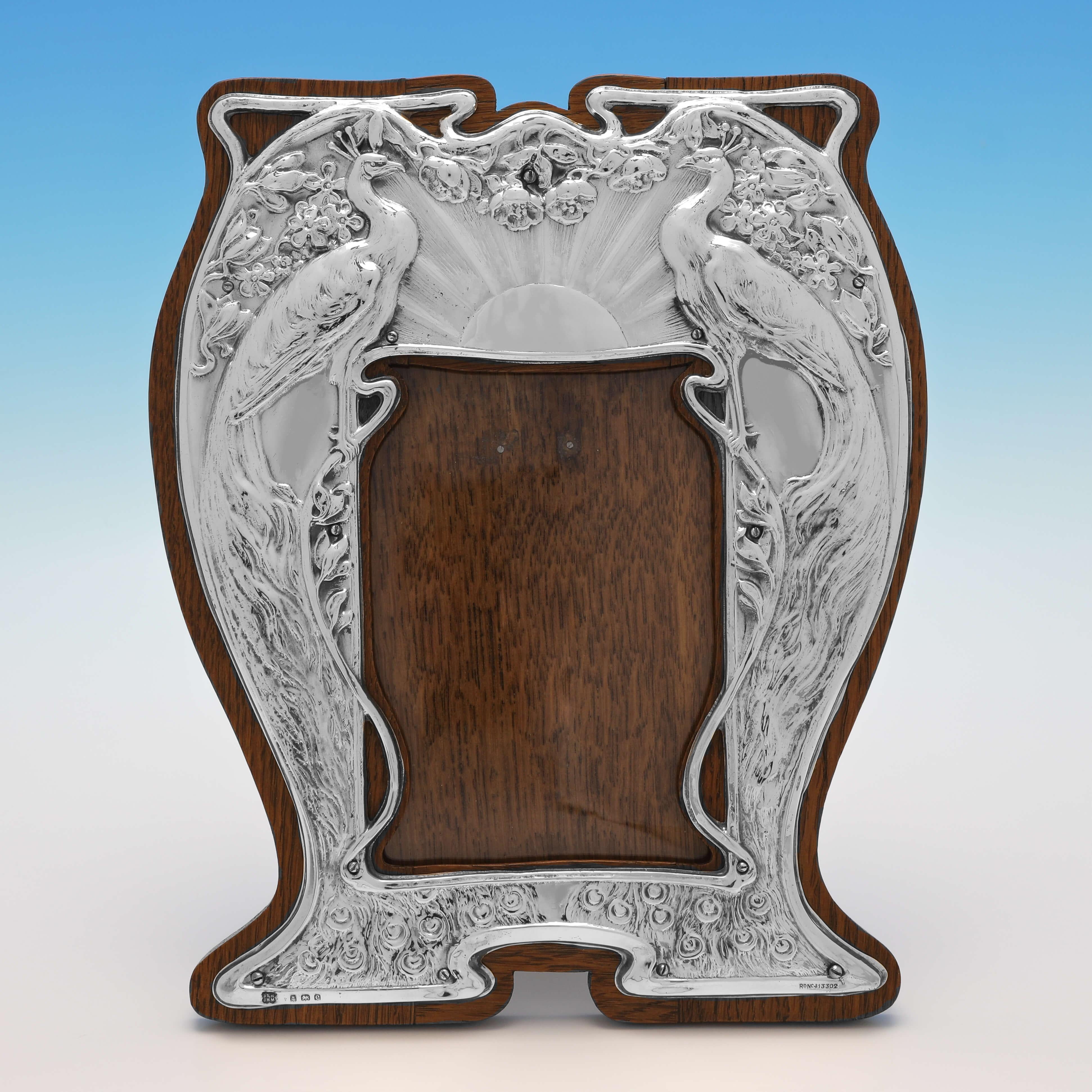 Hallmarked in Birmingham in 1904 by Heath & Middleton, this stunning Antique Sterling Silver Photograph Frame, is a wonderful example of the Art Nouveau taste seen at this time. The photograph frame measures 9.5