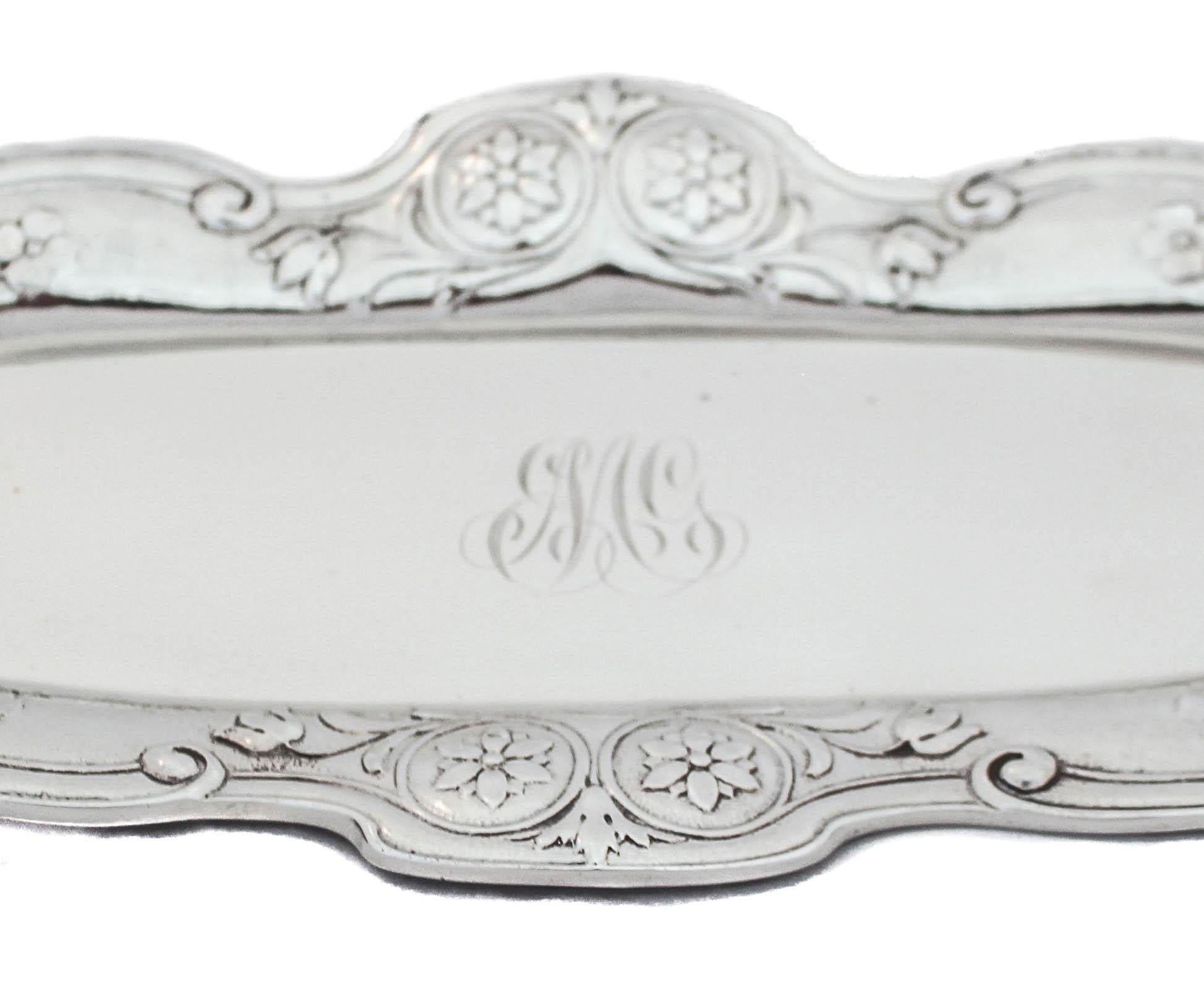 We are proud to offer this sterling silver Art Nouveau ring tray by Gorham Silversmiths of Providence, Rhode Island.  It has a scalloped rim with aesthetic work around the edge.  The edge has a matte finish which in contrast to the center that is