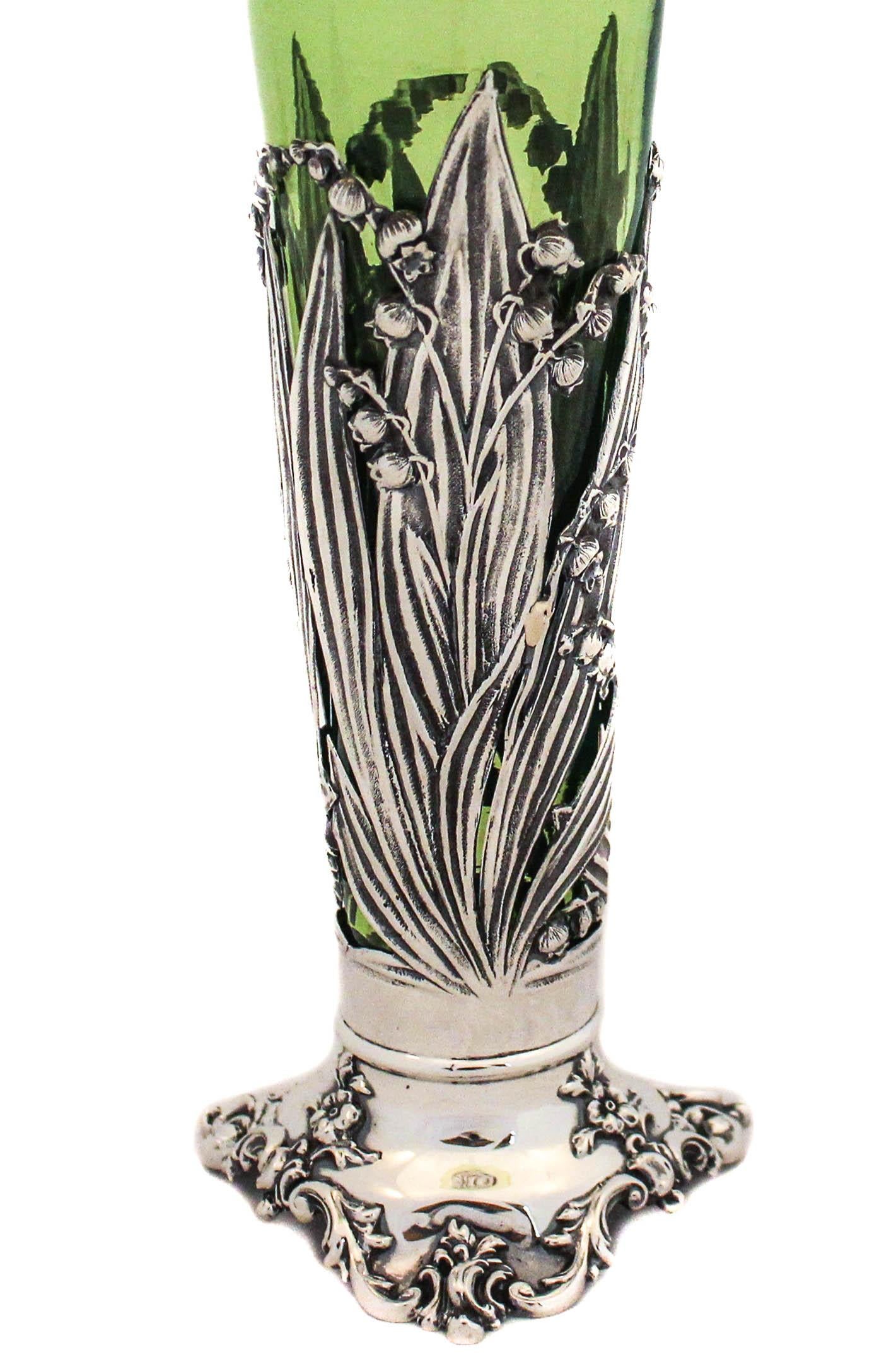 If you love Art Nouveau as much as me, you’ll be very excited by this item. A sterling silver vase with a lime-green liner. The liner is removable so it’s easy to wash, dry and put back in the silver base. The glass rim is fluted in keeping with the