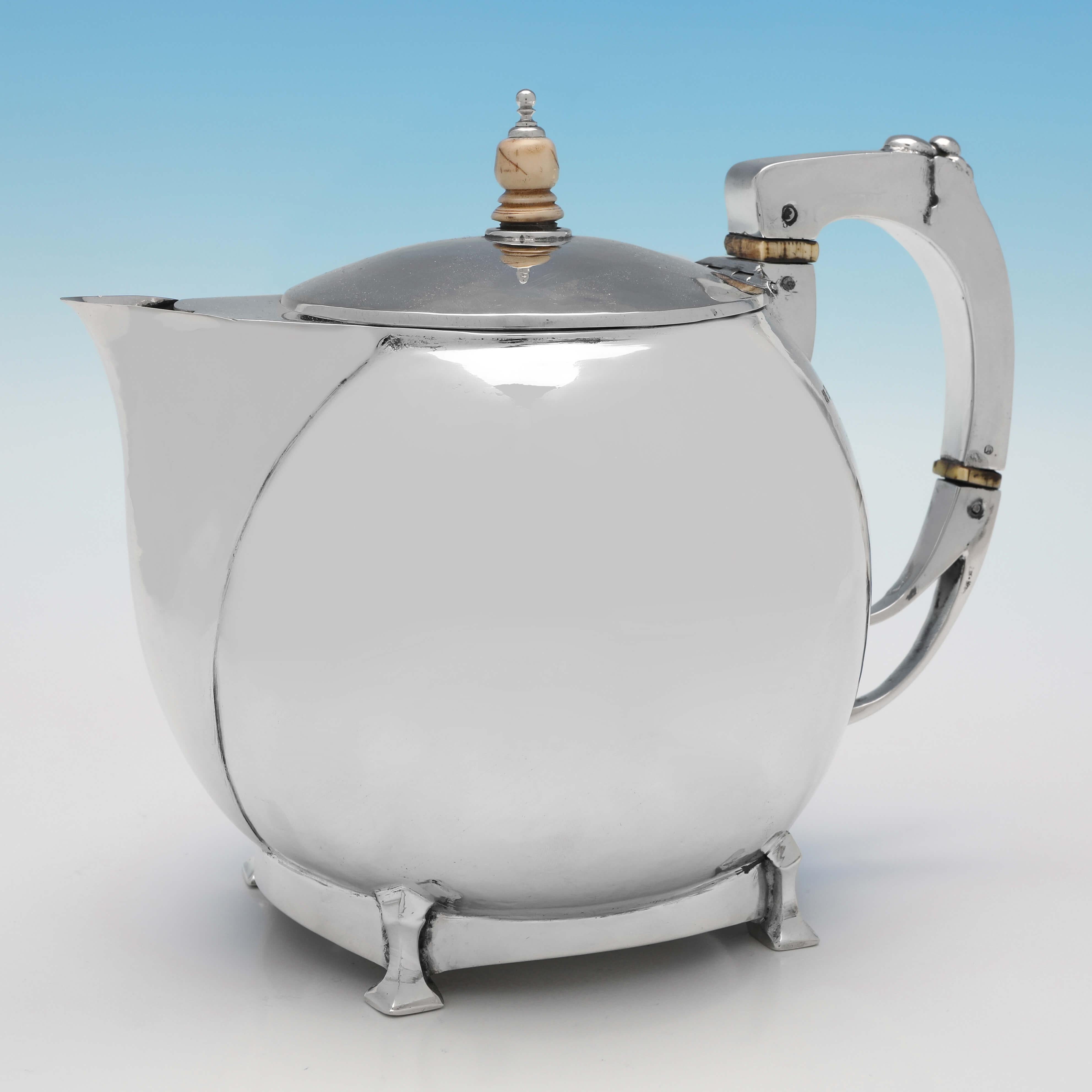 Hallmarked in Birmingham in 1929 (the hot water pot hallmarked in 1935) by William Henry Creswick, this wonderful, 4 piece Sterling Silver Tea Set, is a superb example of Arts & Crafts design. The teapot measures 6.75