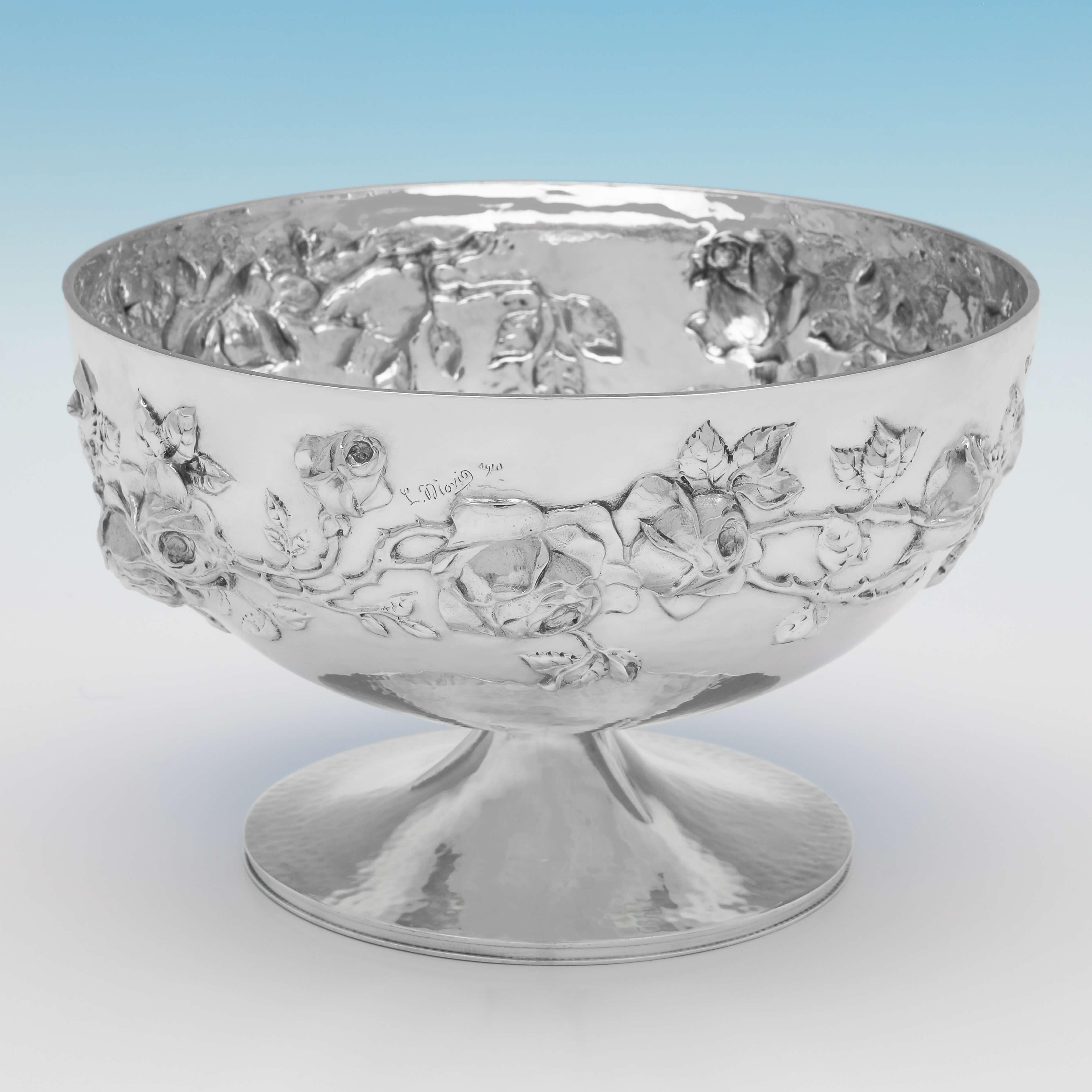 Designed by Latino Movio, and hallmarked in London in 1910 by Goldsmiths & Silversmiths Co., this stunning, Antique Sterling Silver Bowl, is in the Arts & Crafts taste, chased around the body with a floral motif. The bowl measures 5