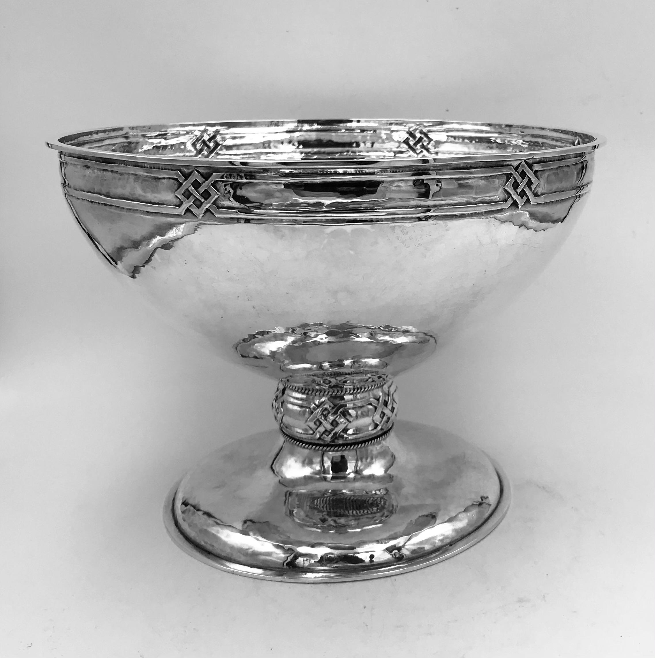 An antique sterling silver Arts & Crafts bowl made by A.E.Jones, Birmingham, England, 1910.
This very stylish bowl has a hammered texture finish and Celtic knot design to the border and stem, in keeping with its arts & crafts origins.