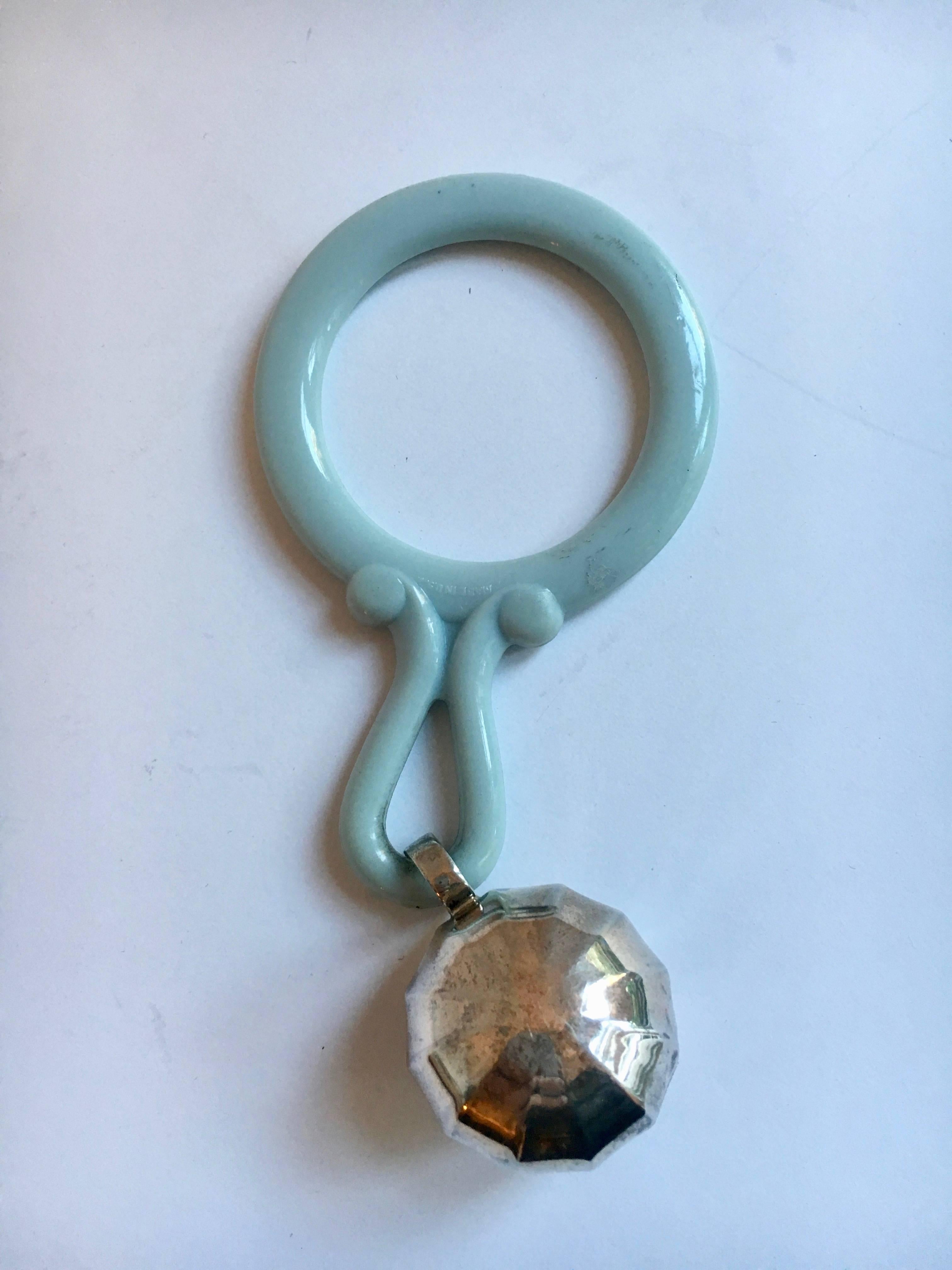 Sterling silver baby rattle and teething ring- a blue plastic tether with a sterling silver rattle / bell - the perfect gift for the baby that has everything.