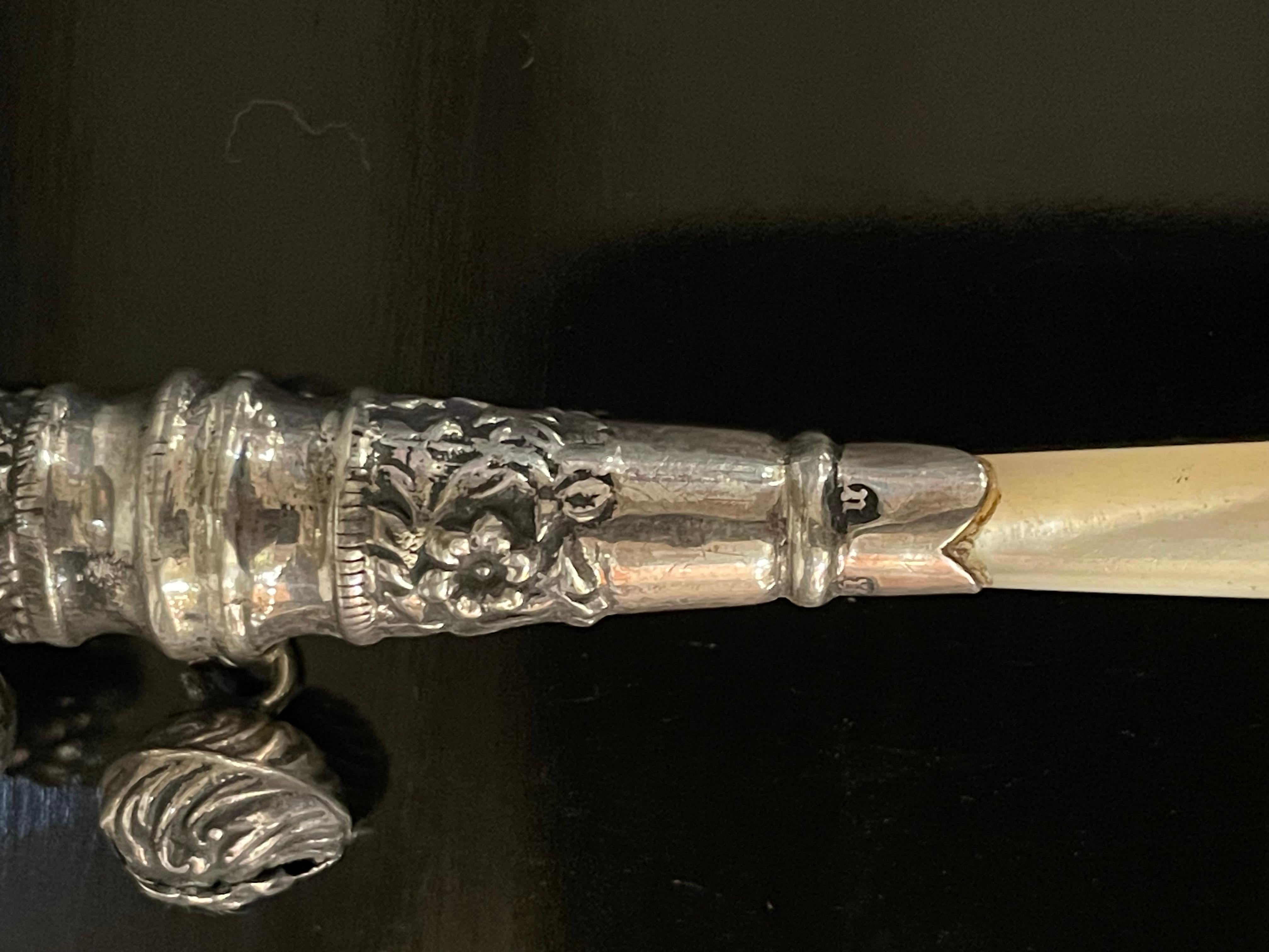 AN ENGLISH STERLING SILVER BABY RATTLE WITH WHISTLE END AND MOTHER OF PEARL HANDLE, MADE IN BIRMINGHAM, CIRCA 1894

Provenance: Private Australian Collection.