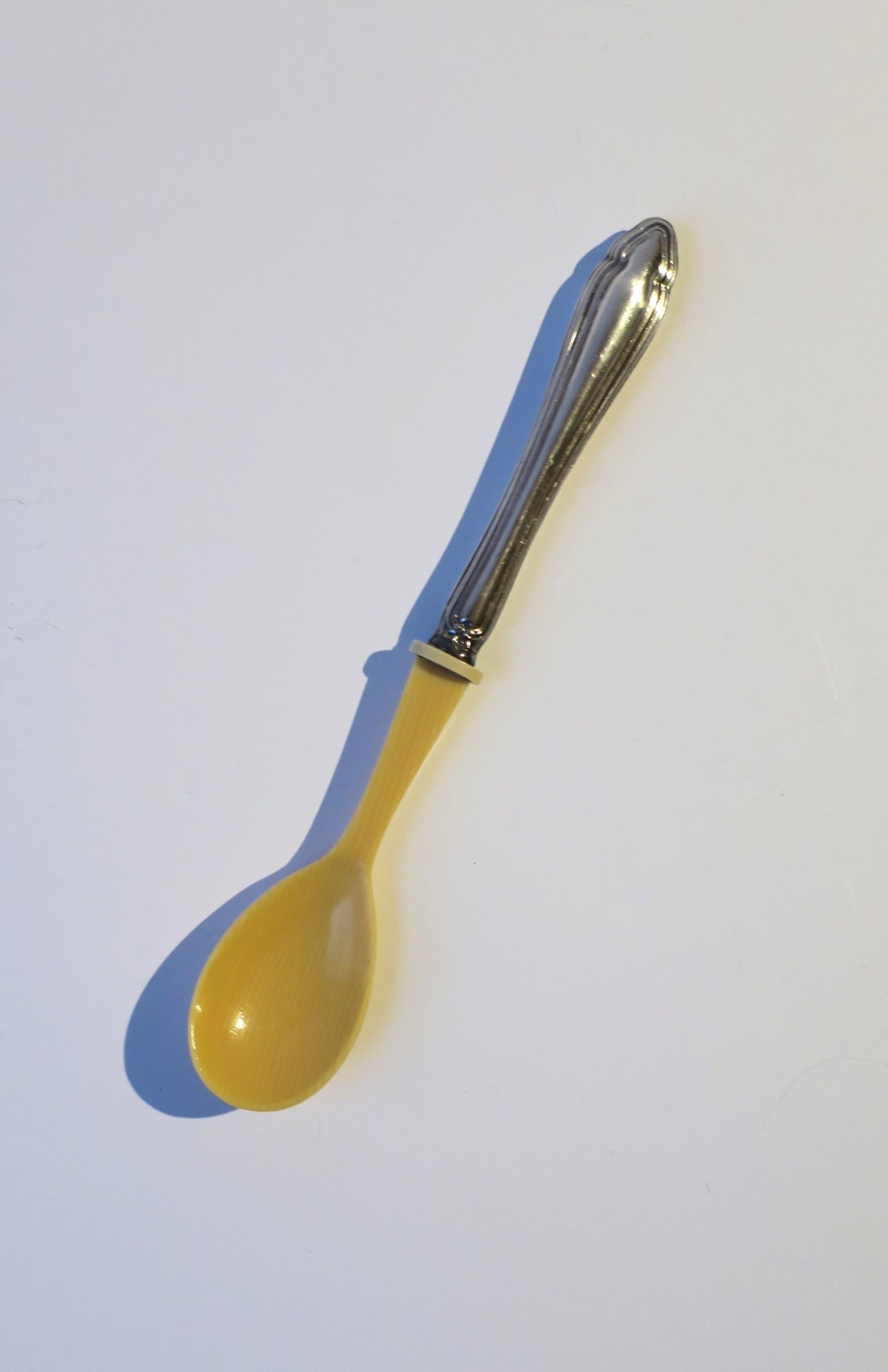 A sterling silver and celluloid baby spoon, circa early-20th century. Piece has a sterling silver handle and celluloid 'bowl'. A beautiful spoon in very good condition, as shown. A great piece for a new baby. Piece would also make a nice gift.