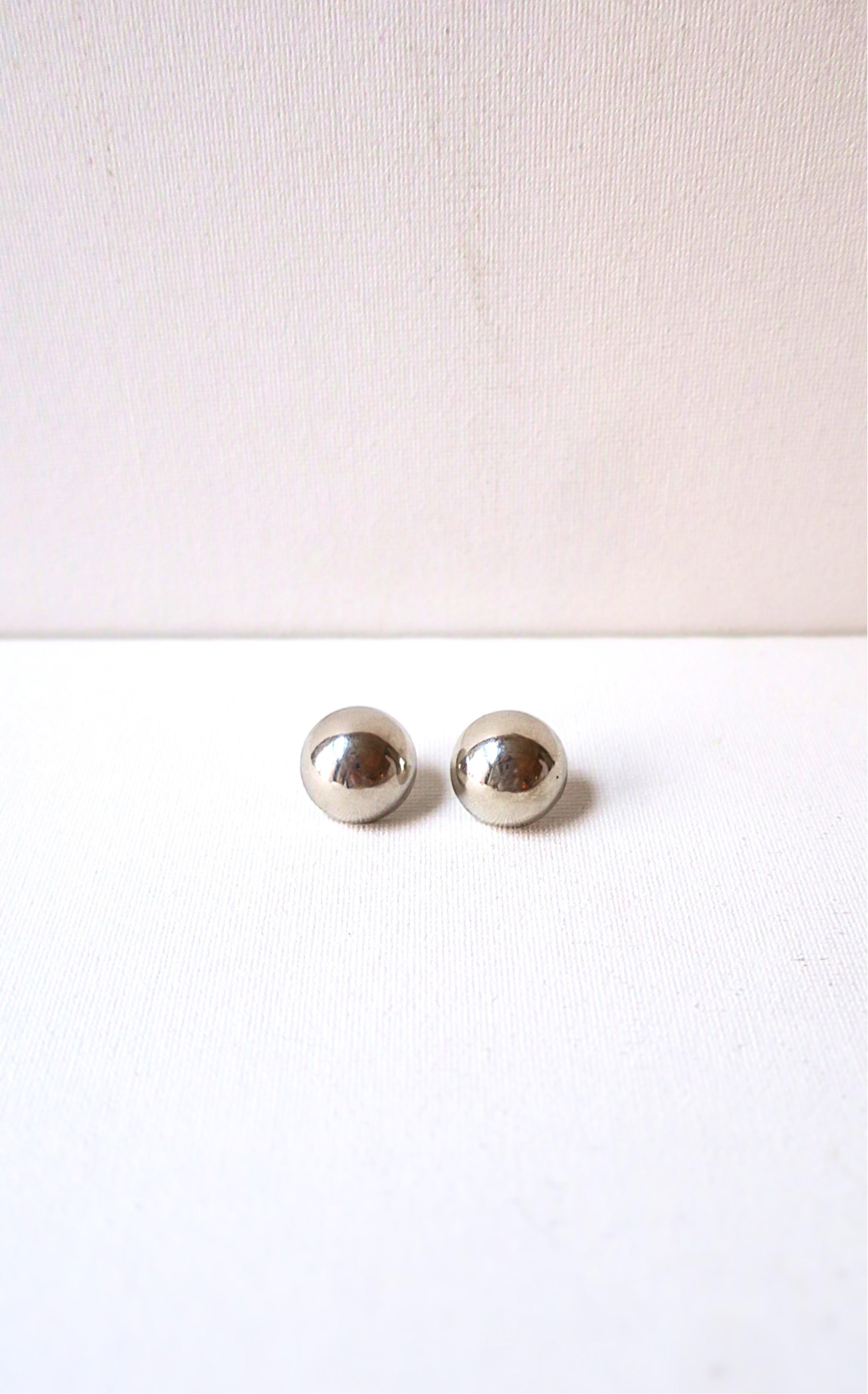A classic pair of sterling silver ball or button earrings. Earrings are half-ball shape/flat at back. '925' marking for sterling silver on back as shown in last image. Very Good condition as shown in images and video. Earrings are a nice size.