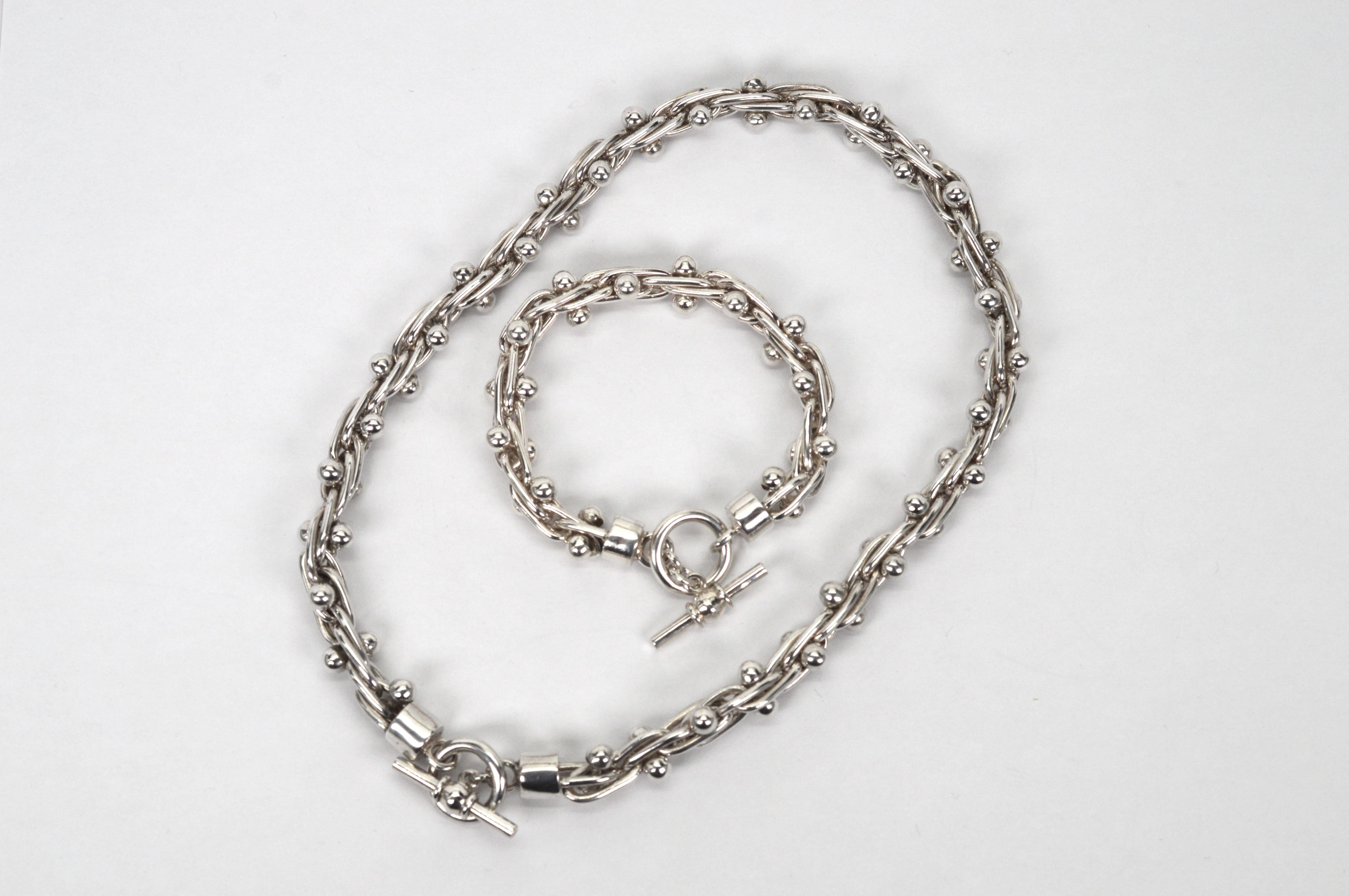 Interesting woven oblong links of .925 sterling silver are accented with 