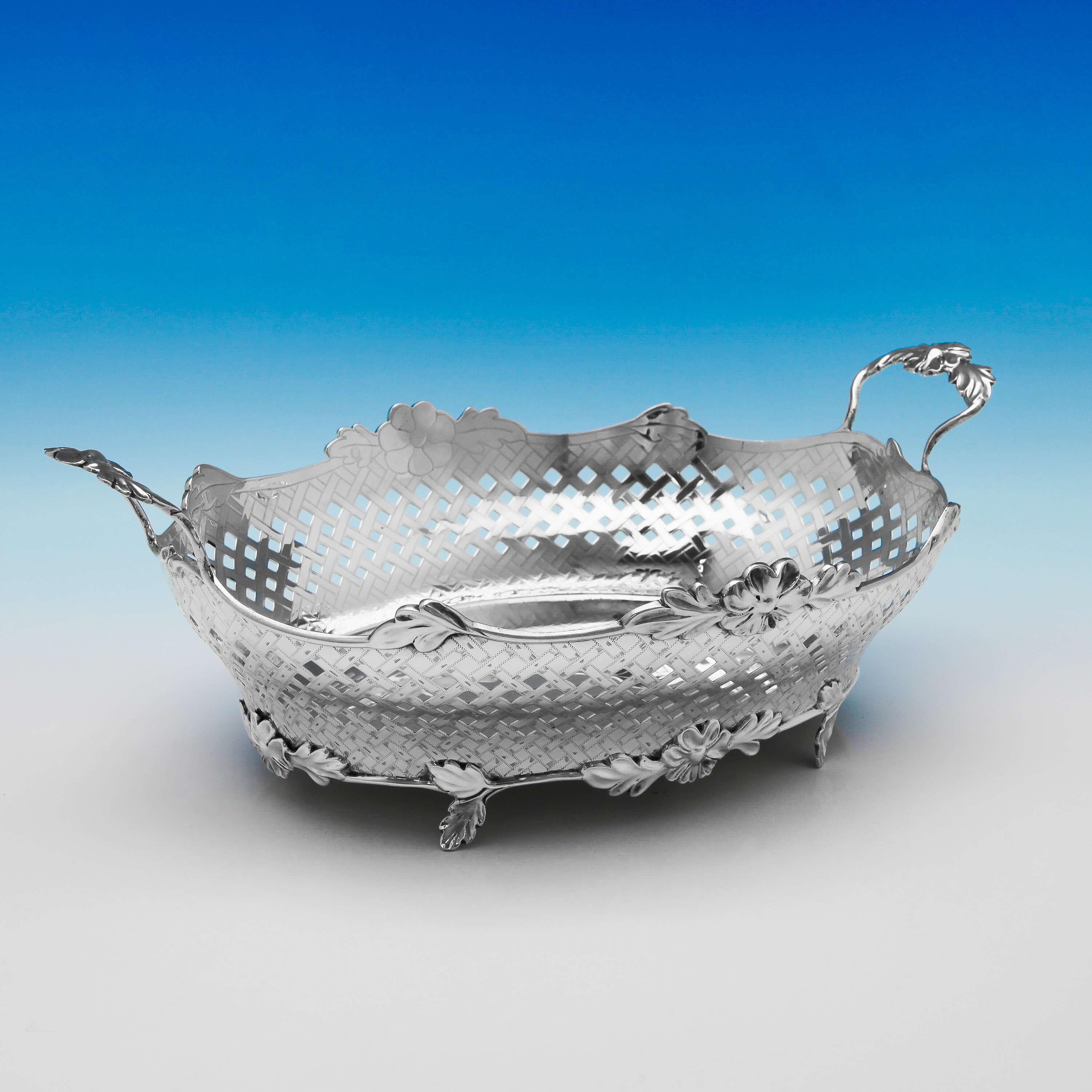 Hallmarked in London, 1898 by Charles Stuart Harris, this stylish, Victorian, antique, sterling silver basket, stands on cast naturalistic feet, and features a basket weave finish to the body, and cast and applied handles. The basket measures 5.25