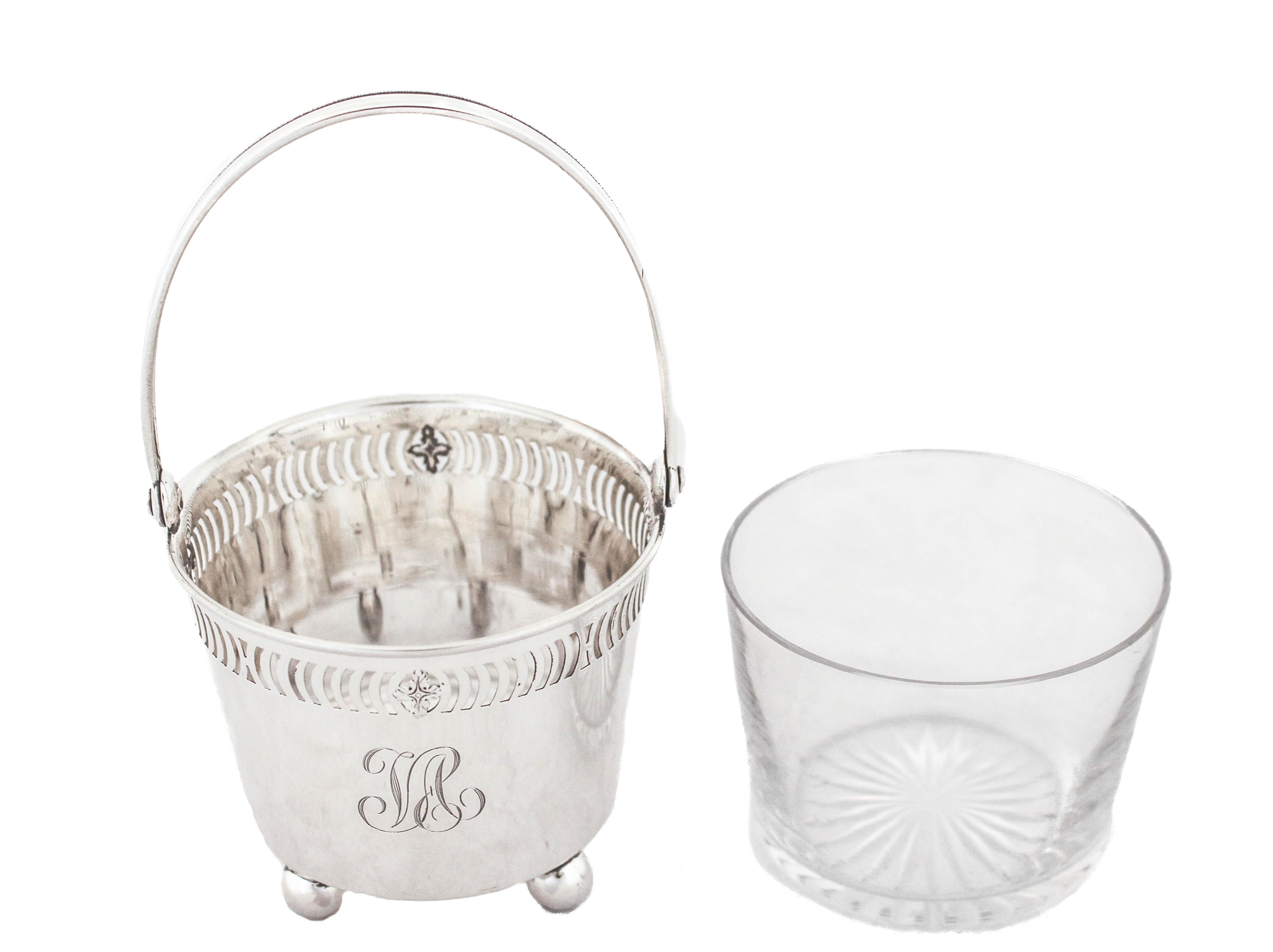 Being offered is a sterling silver basket with the original glass liner by International Silver.  This adorable basket stands on four balls so it’s propped off the surface.  It has a reticulated design around the top and a handle that folds down. 