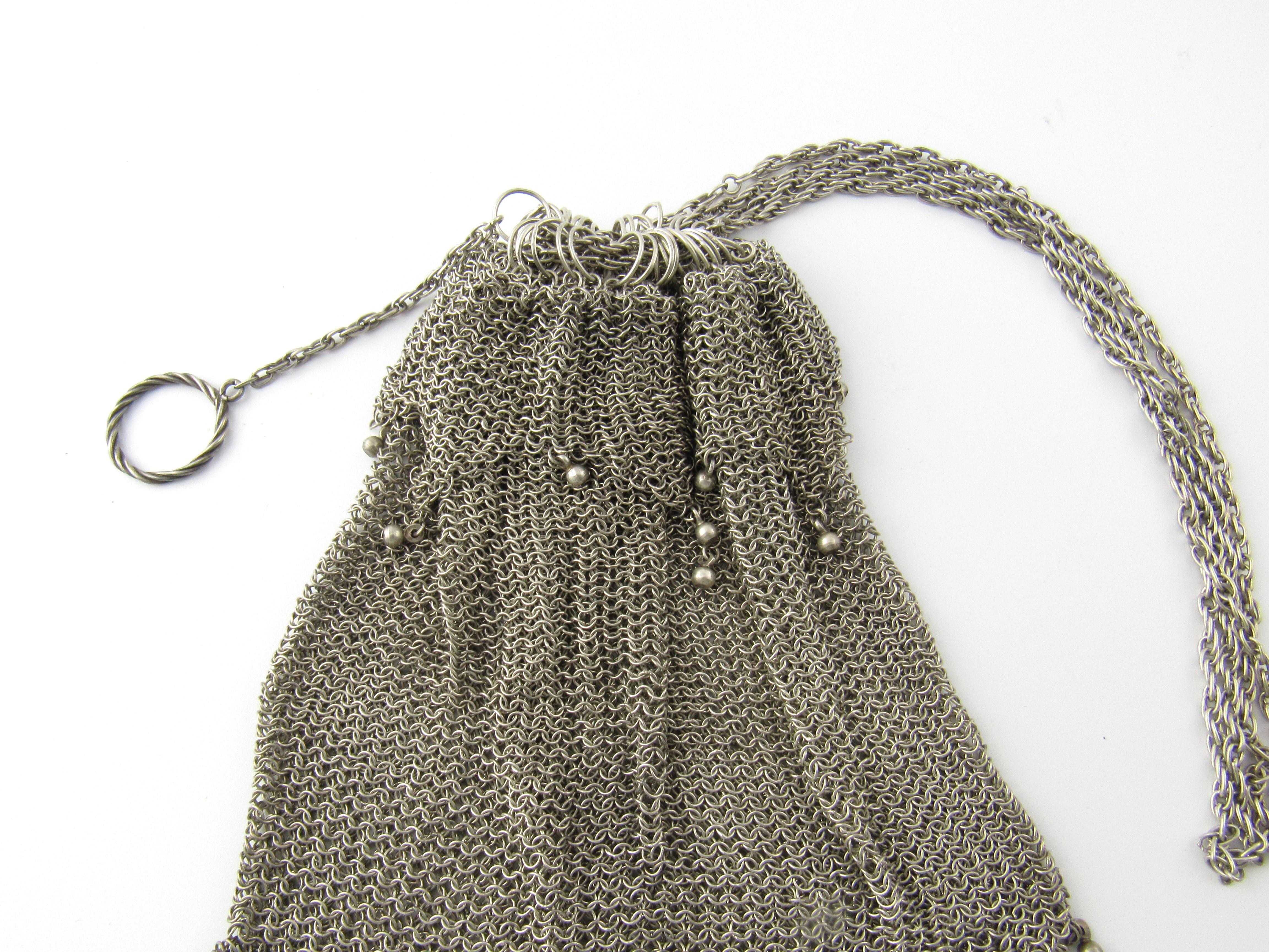 Vintage Sterling Silver Beaded Mesh Purse Pull Closure

This is a beautiful sterling silver beaded mesh purse with pull closure. The purse is embellished with silver dangling beads from the puse. You will simply be delighted with the condition,