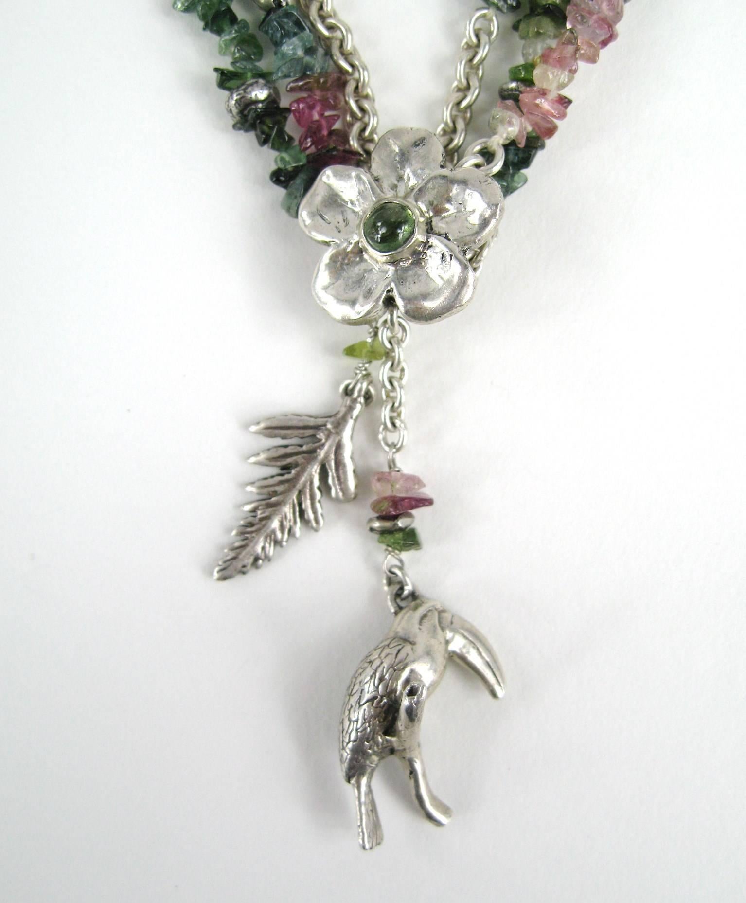 Earlier piece of Cummings work - late 1980s hand scripted on the toggle. Sterling and beads make up this one. 17in end to end. Flower with amethyst cabochon in the center. Bird, leaf and Parrot charms. There are more pieces of Cummings on our