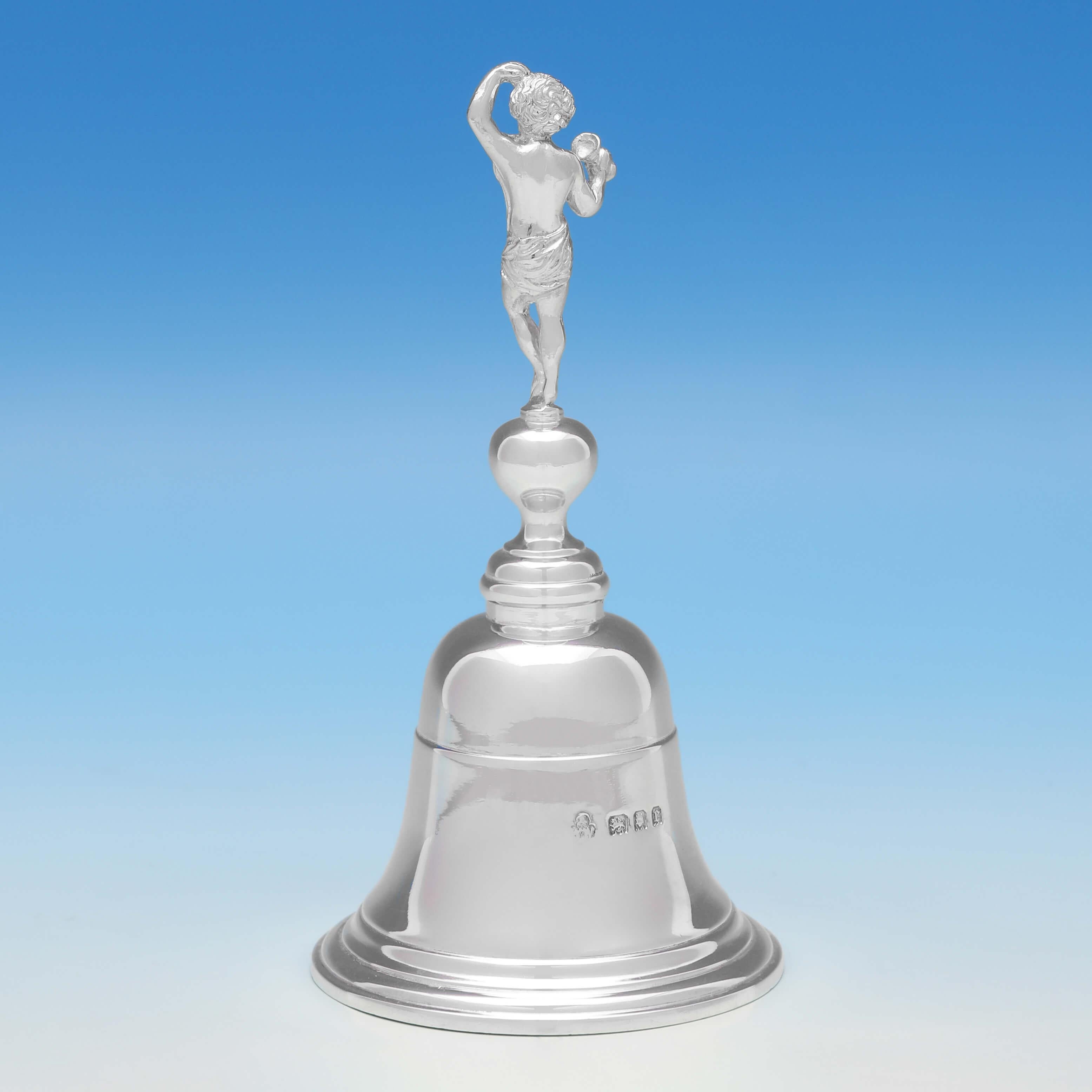 Hallmarked in London in 1920 by Wakely & Wheeler, this unusual, antique sterling silver bell, features a figural handle, and reed detailing. The bell measures 4.5
