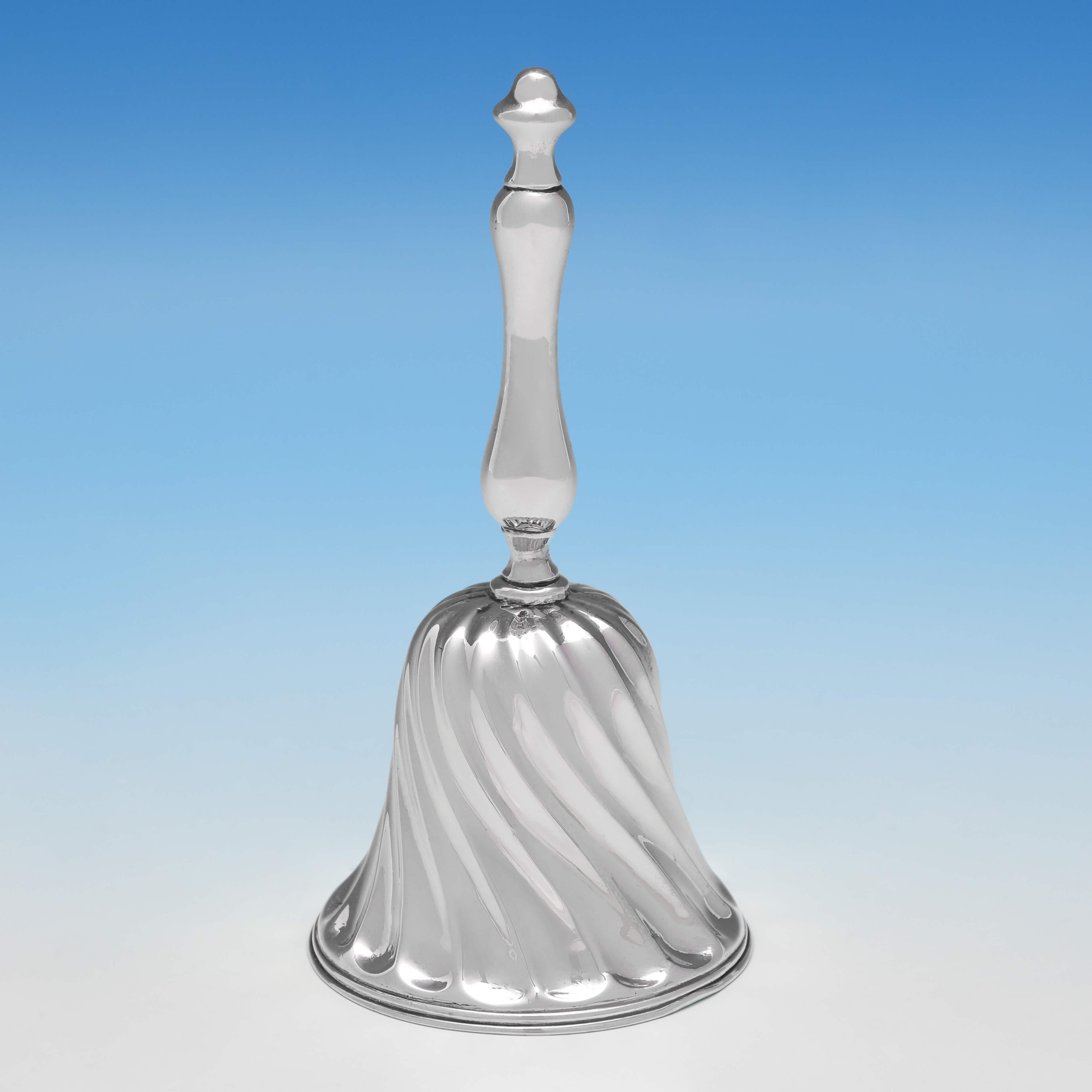 Hallmarked in London in 1900 by Harry Brasted, this attractive, Victorian, antique sterling silver bell, features swirled sunken fluting, and a reed border. The bell measures 4.5