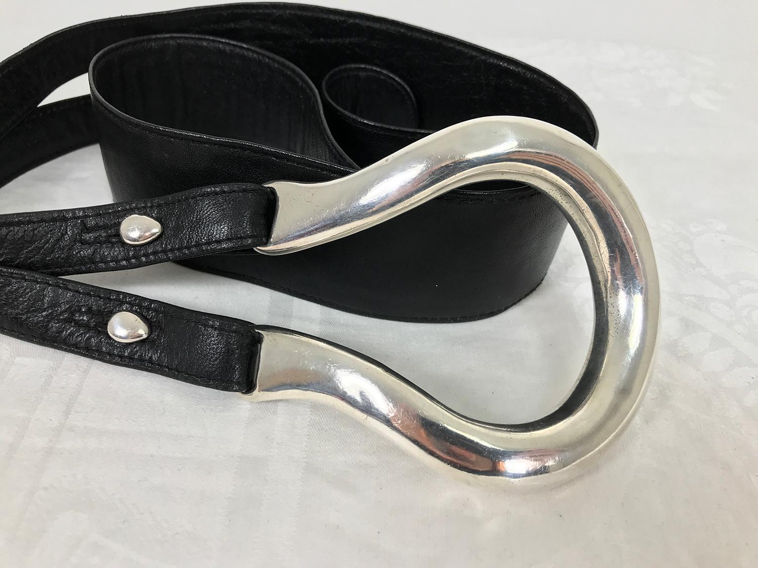 Large sterling silver horse shoe belt buckle and three leather belt straps, the white one is marked Tiffany. The buckle isn't marked anything but has tested sterling, the buttons are marked sterling. These belts designed by Elsa Peretti for Tiffany