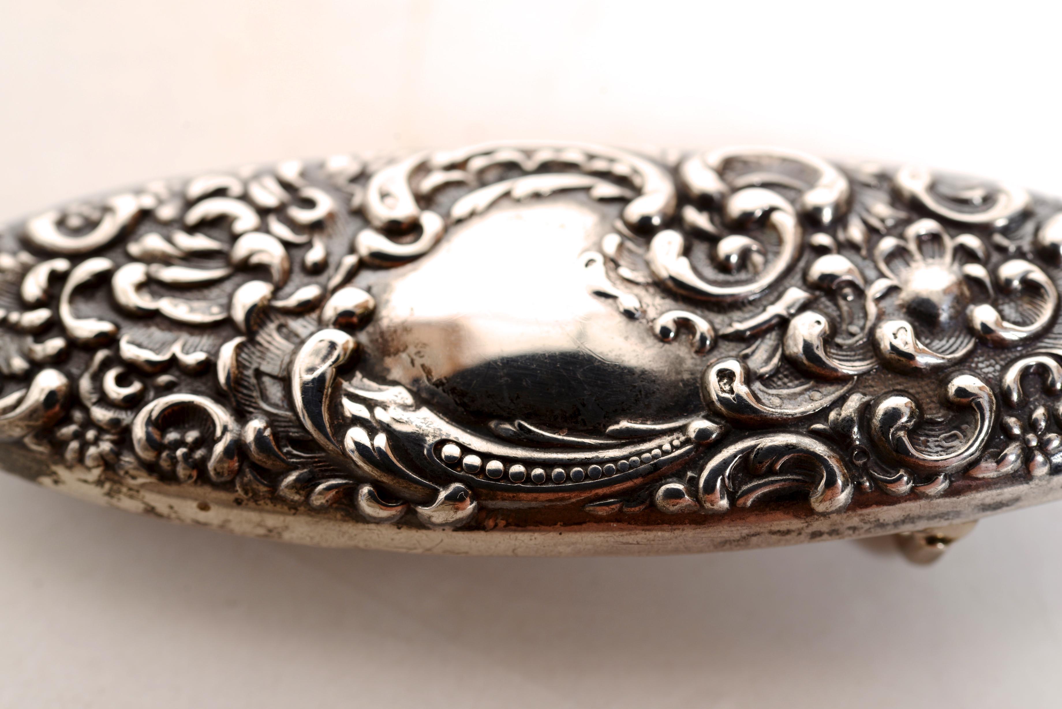 Fibbia da cintura in argento sterling con decorazioni floreali e di foglie, 1840 circa. Il disegno di fiori e conchiglie stilizzate è nitido e presenta una bella patina. Il centro ha un posto per le iniziali ma non è mai stato inciso. La fibbia è