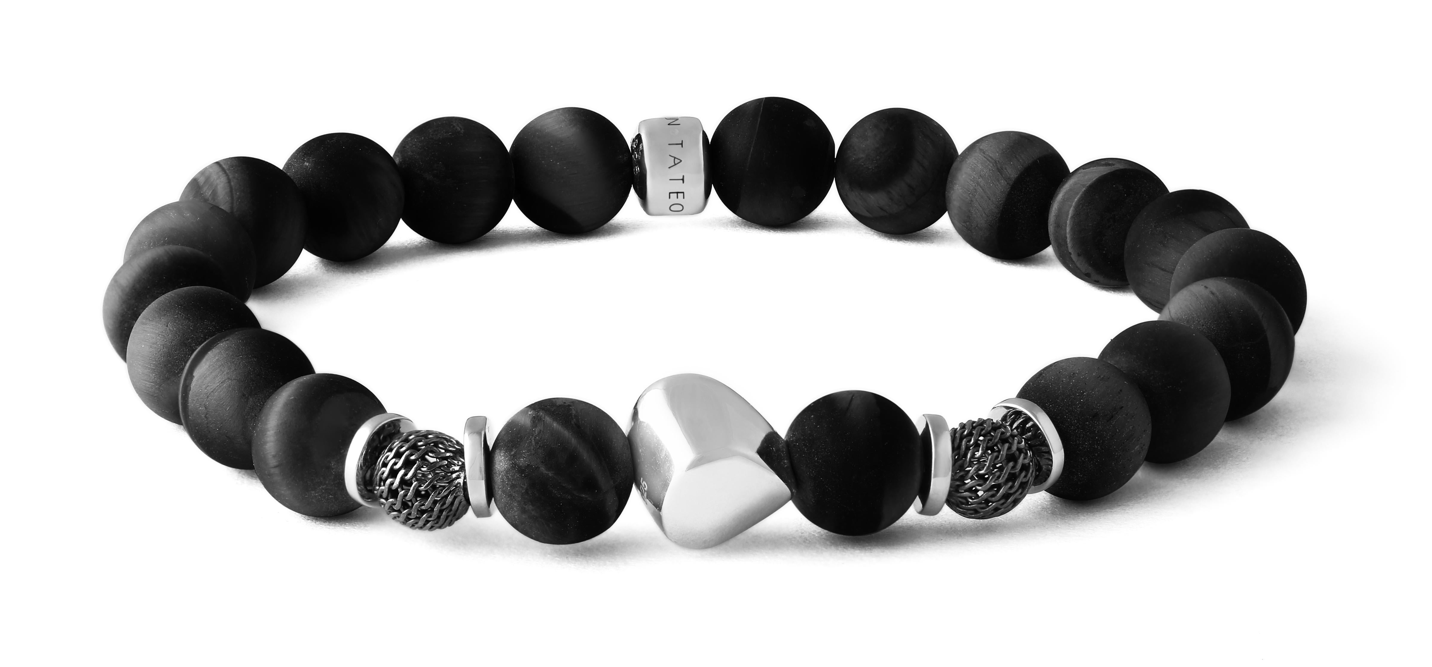 Discover our unique bracelets which feature an organic-shaped silver boulder with contrasting industrial black rhodium mesh beads either side, drawing on the striking contrast of mechanical and natural. Also encompassed by silver discs, this