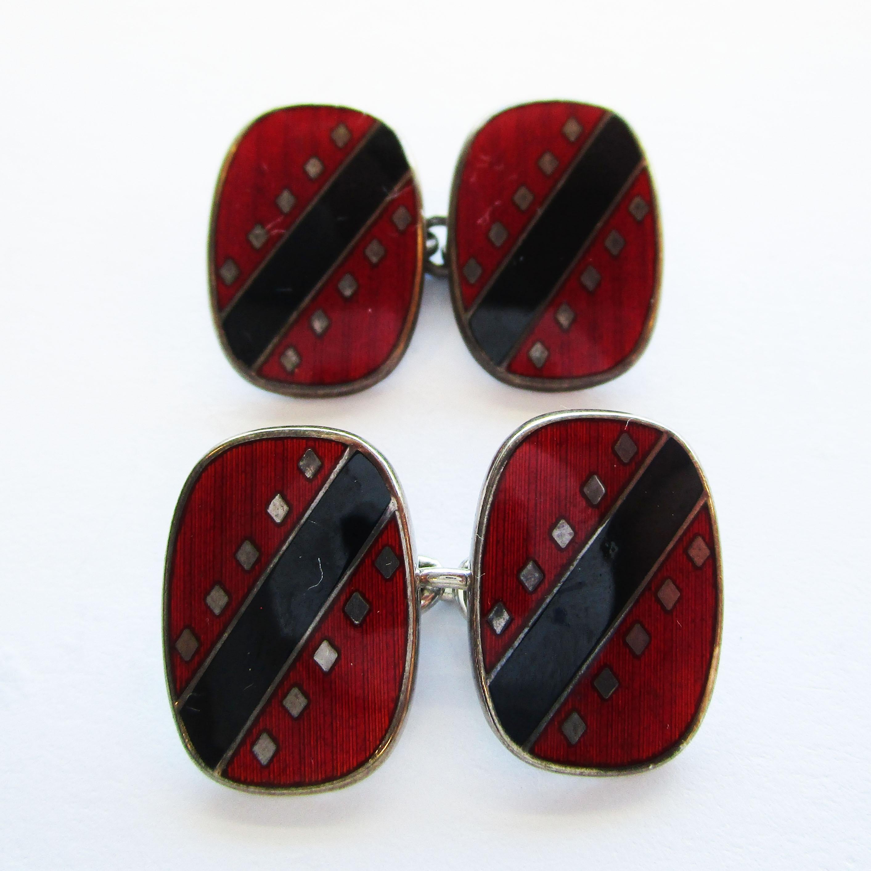 This fantastic pair of cufflinks is in sterling silver and features stunning red and black enamel. The subtle linear design of the enamel is made dramatic in rich red and deep black, and works to create a classic and elegant look that should be a