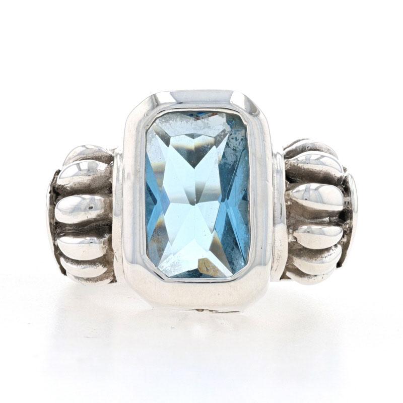Size: 7 3/4
Sizing Fee: Down 2 or up 1 for $30

Metal Content: 925 Sterling Silver

Stone Information
Glass (simulated blue topaz)
Cut: Radiant
Color: Blue

Style: Cocktail Solitaire

Measurements
Face Height (north to south): 5/8