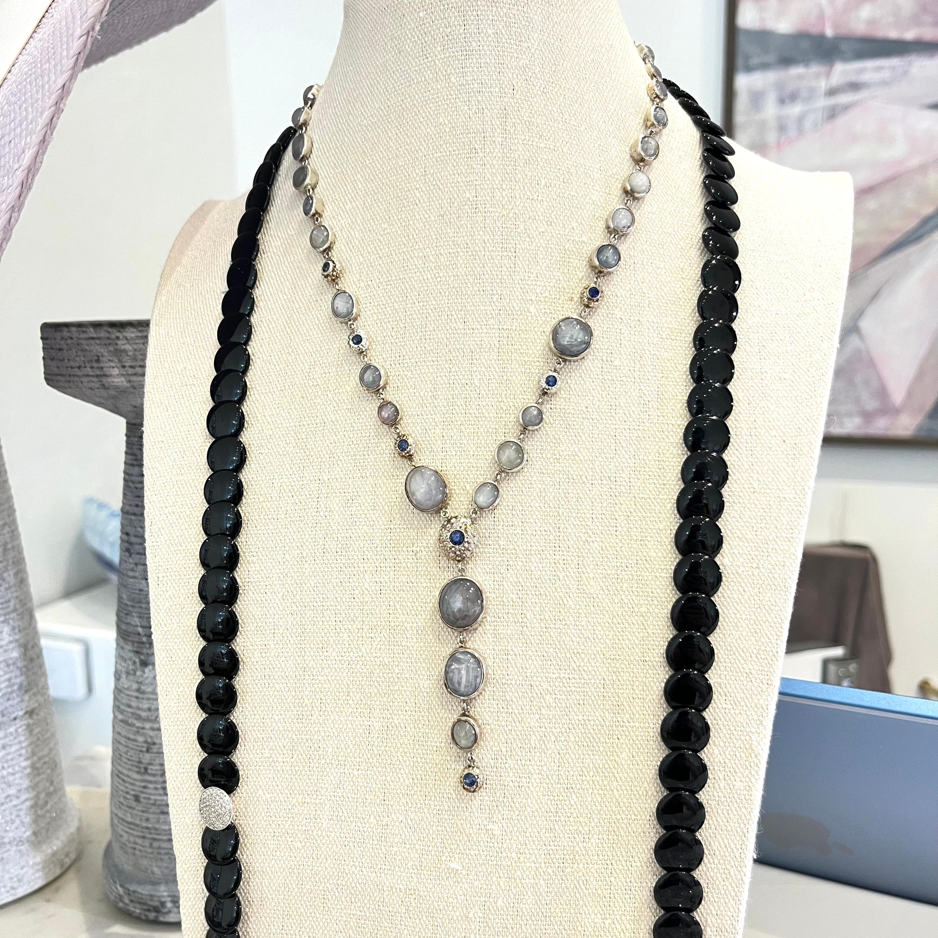 Star sapphire urchin necklace with brilliant cut ceylon blue sapphire lariat, handcrafted to fashion perfection. Each bezel is uniquely designed to each stones raw form, with natural baby sea urchins, hosting ceylon sapphire gems. 

- Sterling