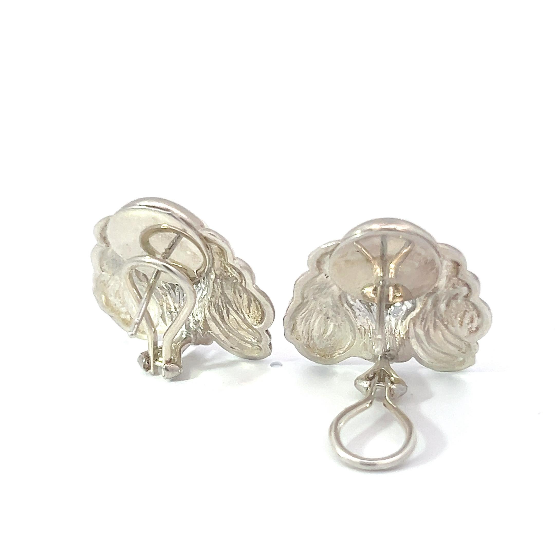 These charming earrings, crafted from sterling silver, beautifully capture the likeness of a Cocker Spaniel's head. Each earring is meticulously carved to showcase the intricate details of the beloved breed, from the flowing ears to the expressive