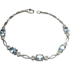 Pulsera de eslabones de plata de ley con topacio azul y detalles marquesa y redondos