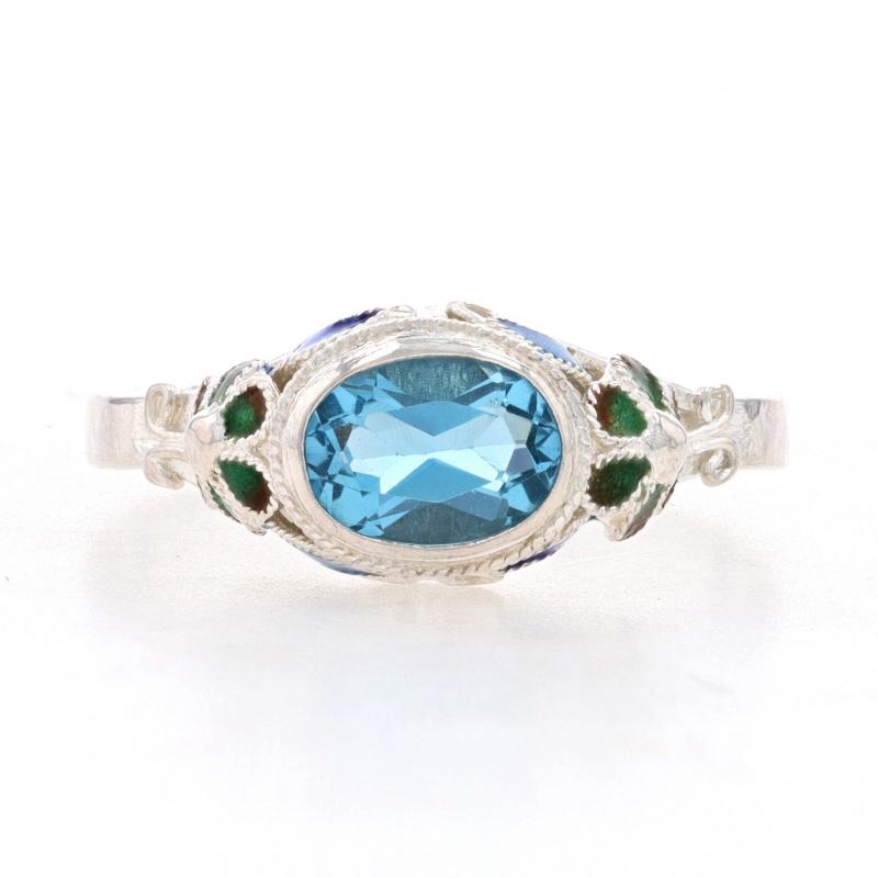 Size: 7 3/4

Metal Content: 925 Sterling Silver

Stone Information

Natural Blue Topaz
Treatment: Routinely Enhanced
Carat(s): 1.20ct
Cut: Oval

Total Carats: 1.20ct

Material Information

Enamel
Color: Blue, Green & Brown

Style: Solitaire 
Theme: