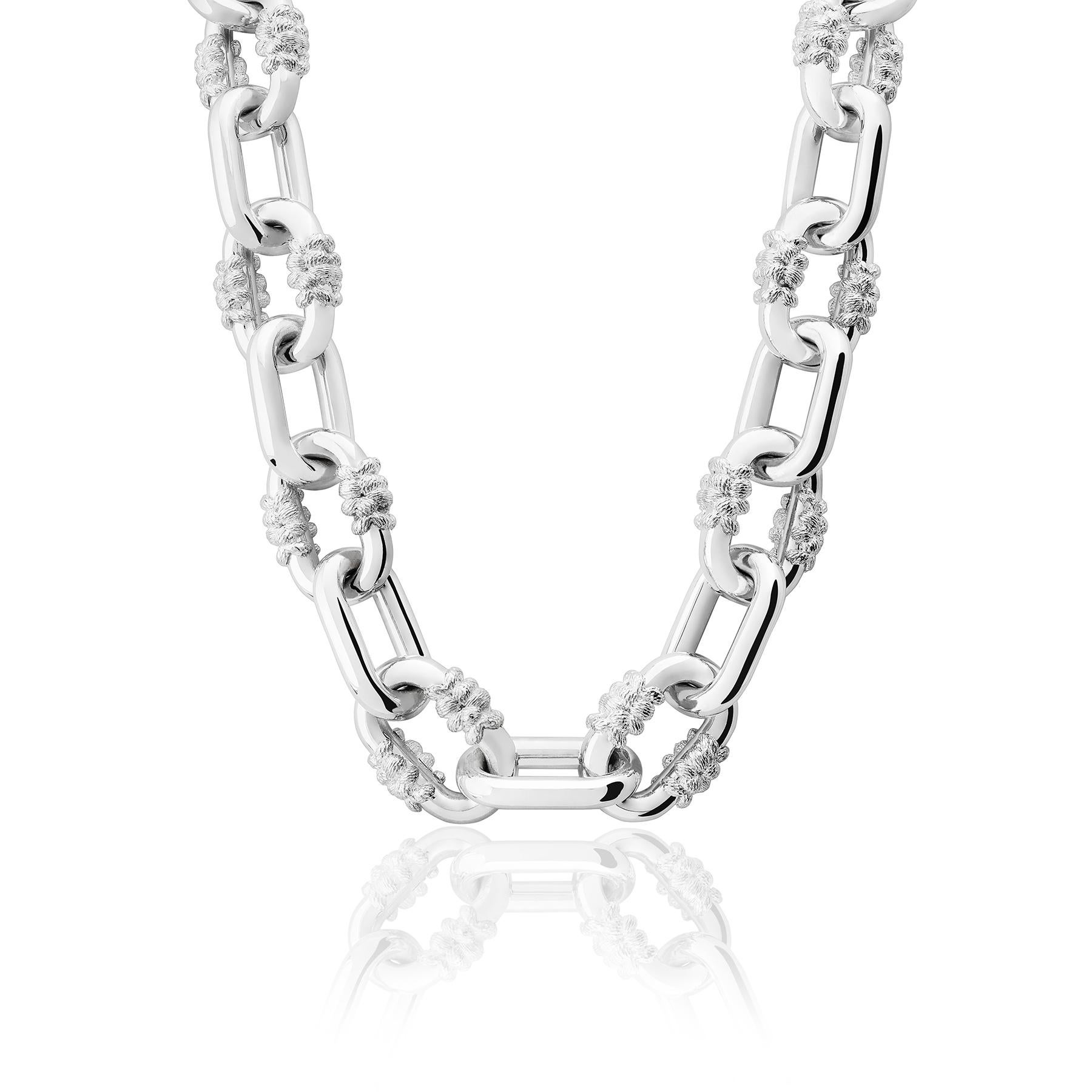 The Bordados Chain Choker from the Bordados Collection by TANE is handmade in sterling silver. The piece consists of a series of links interspersed between a polished finish and those that support the motifs of the collection, whose texture