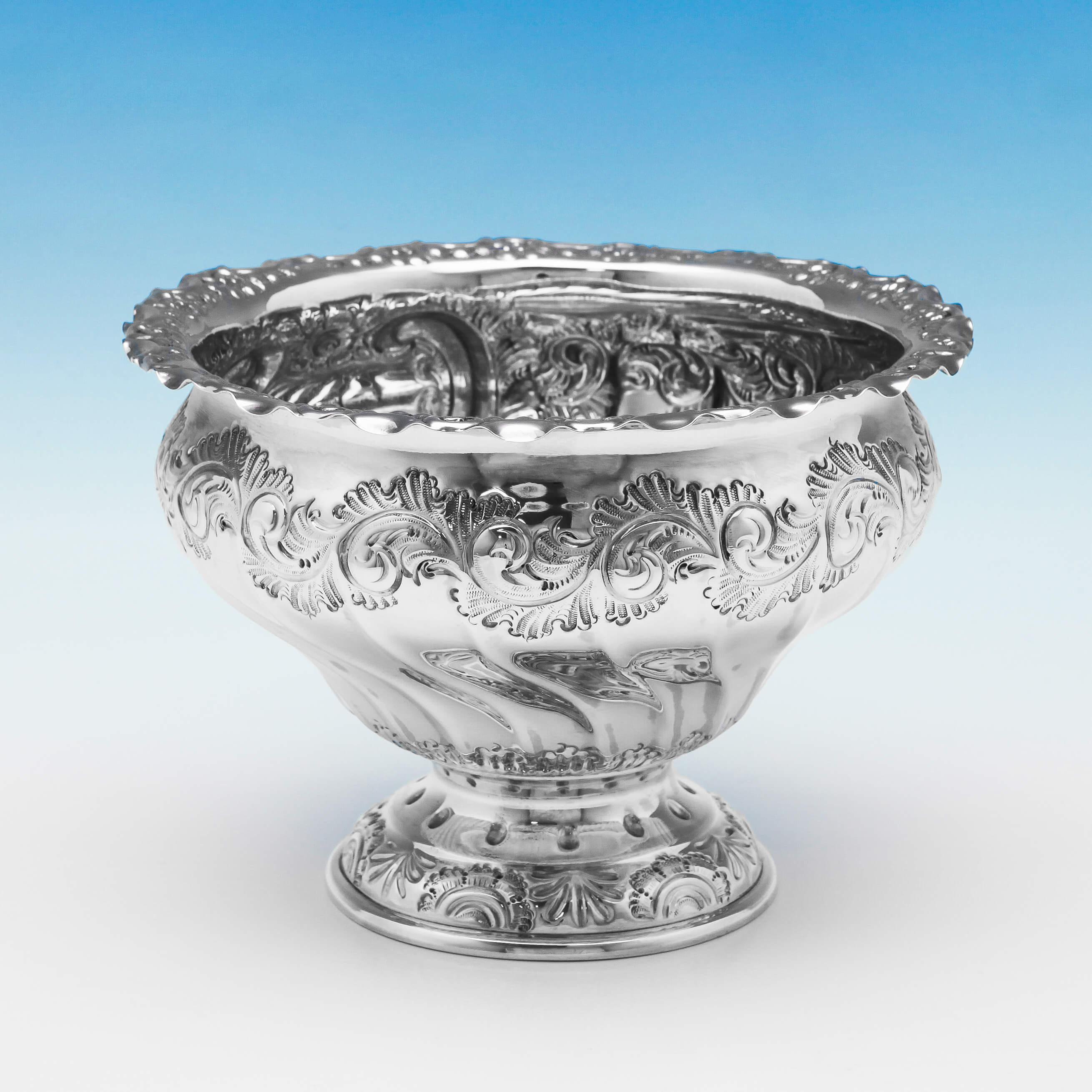 Hallmarked in Sheffield, 1902 by Henry Atkin, this delightful, ornate, antique silver bowl, is tulip shaped, and features chased floral and scroll decoration, and a shaped rim. The bowl measures 4.5 inches (11.5cm) tall, by 6.75 inches (17cm) in