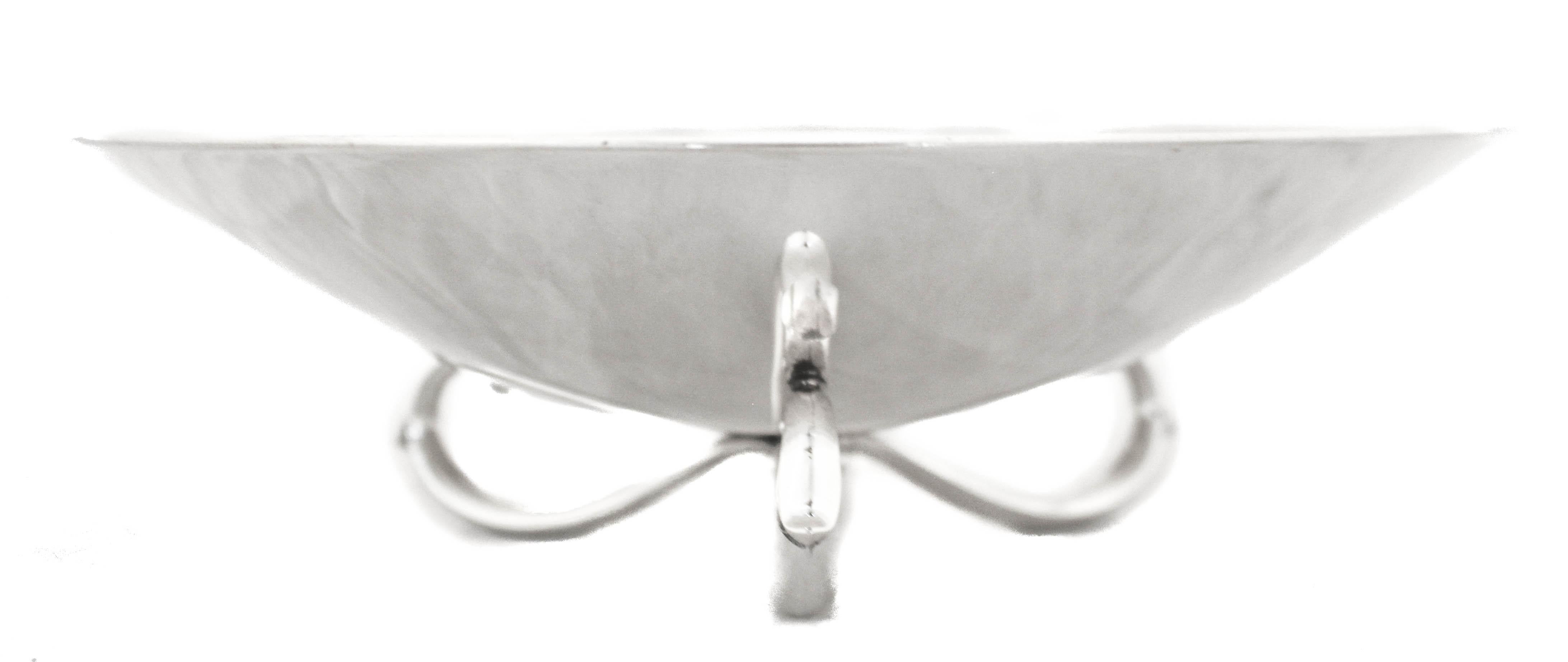 We are happy to offer you this sterling silver bowl by Wallace Silversmiths from the 1940’s. It has a sleek look with a curved three-loop base. Although it was manufactured before the Mid-Century movement it has that Mid-Century look and feel;