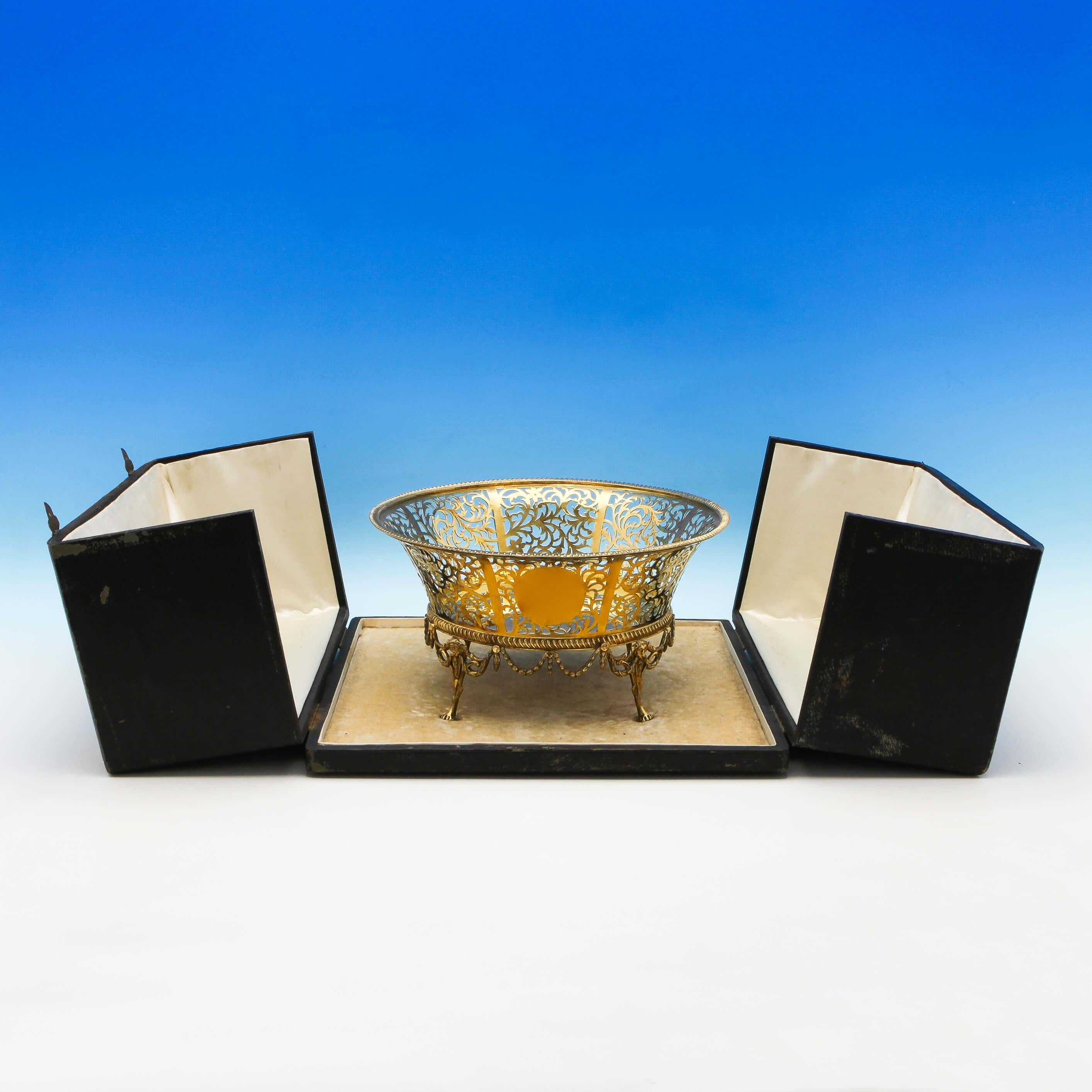 Hallmarked in London in 1909 by Goldsmiths & Silversmiths Co., this striking, Edwardian, antique sterling silver bowl, is gold-plated and features pierced decoration throughout, cast and applied legs, and is presented in its original fitted box. The
