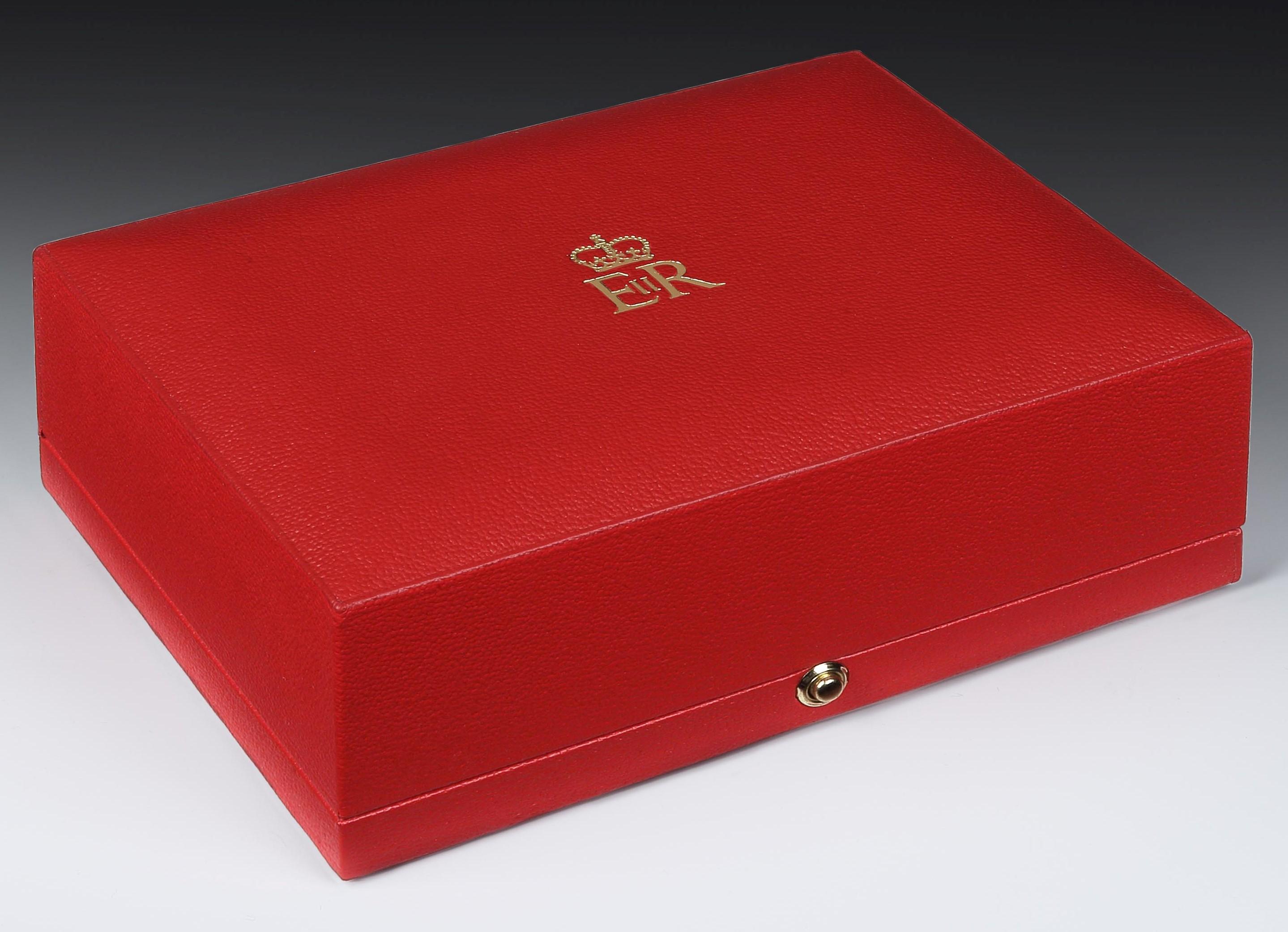 Garrard & Co.

A rare Sterling silver box of outstanding quality, the body of the box has a striped etched detail, and the lid has an applied gold crowned cipher for HM Queen Elizabeth II and is edged with a raised floral border which is echoed