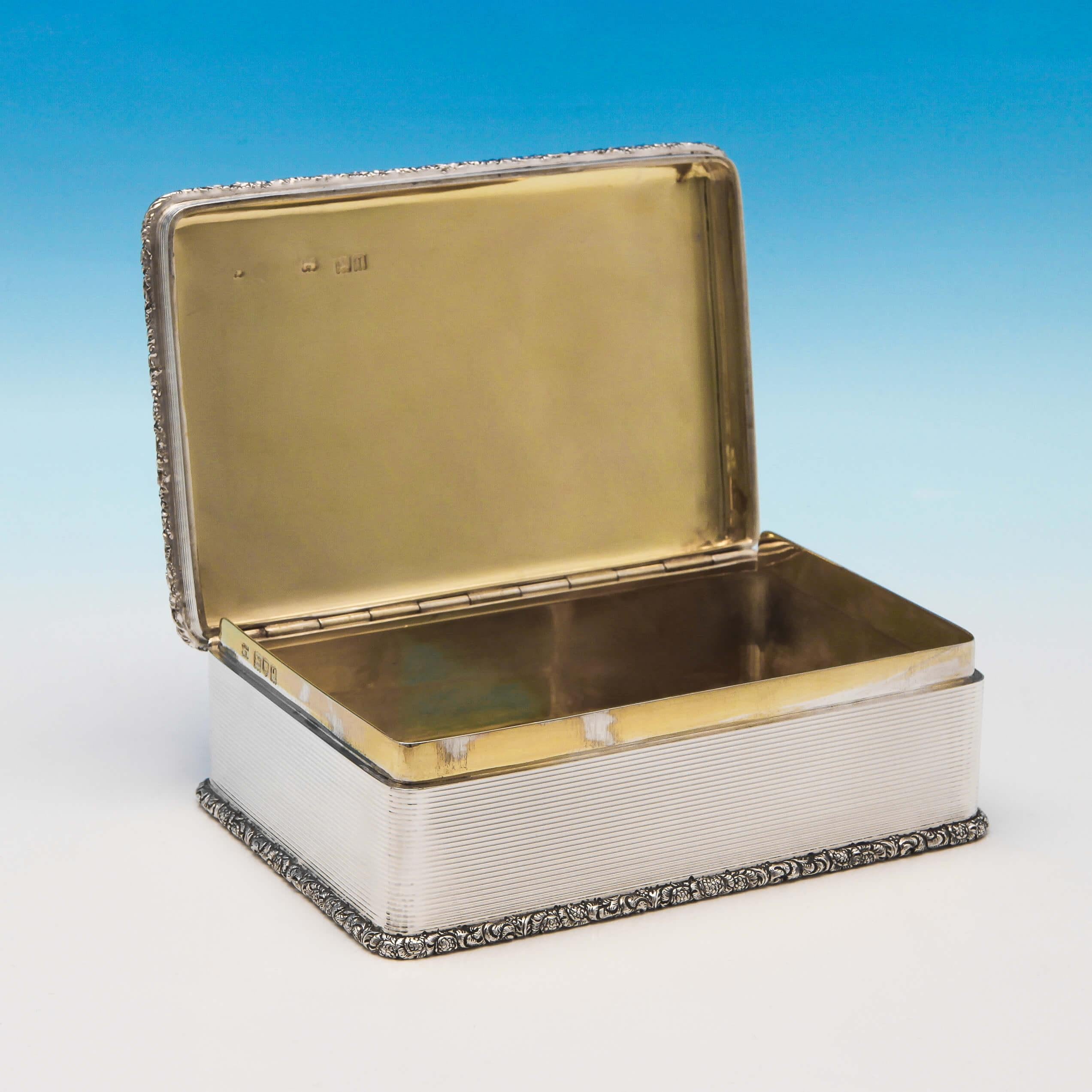 Hallmarked in London in 1911 by D. & J. Wellby, this exceptional, Antique, sterling silver table snuff box, is rectangular in shape, and features a cast border, gilt interior, and engine turned decoration. The snuff box measures 2.25
