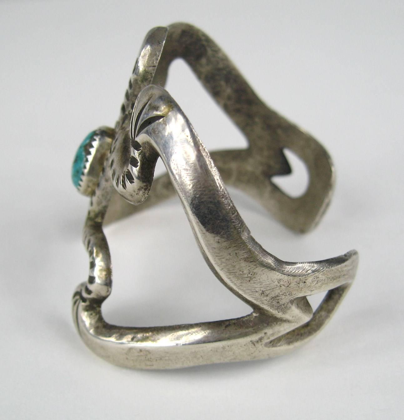 Navajo Sterling Silver sand cast cuff bracelet. Frog Motif With Bezel Turquoise stone The bracelet is not signed as it is common for older pieces from the pre 1950 era. it has a great patina. Measures 2.06 in top to bottom . Opening is 1.07 in. Will