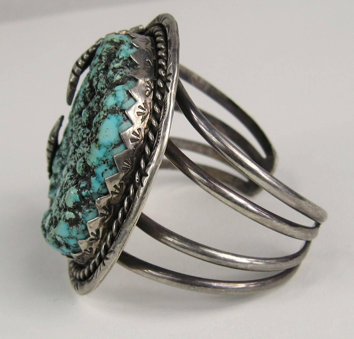 Amazing craftsmanship on this sterling silver bracelet. Large Sea Foam Turquoise set in a feathered sterling 4 rung hand crafted bracelet. The bracelet measures 2.42in. x 2.24 in. wide. Hallmarked inside the bracelet. We have a necklace that will