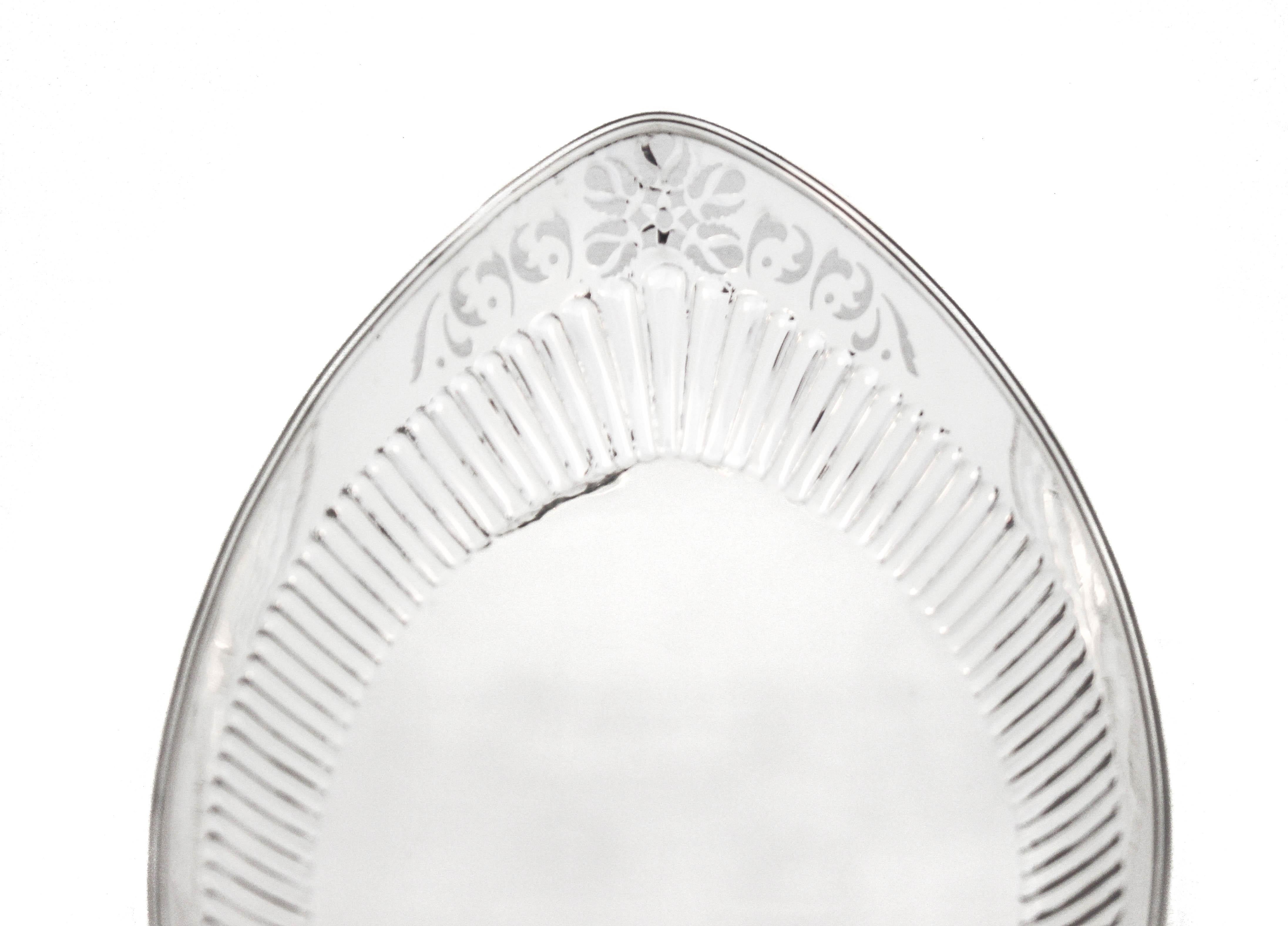 Being offered is a sterling silver breadbasket by Gorham Silversmiths of Providence, Rhode Island.  In addition to the sterling and Gorham hallmarks, it is signed (hallmarked)1911.  It has ridges along around the interior and a cutout design on each