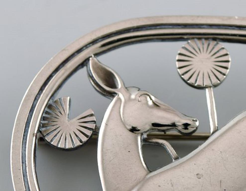 Sterling silver brooch by Georg Jensen. Design number 256. Deer motif.
Stamped.
In very good condition.
Measures: 4.6 x 3.7 cm.