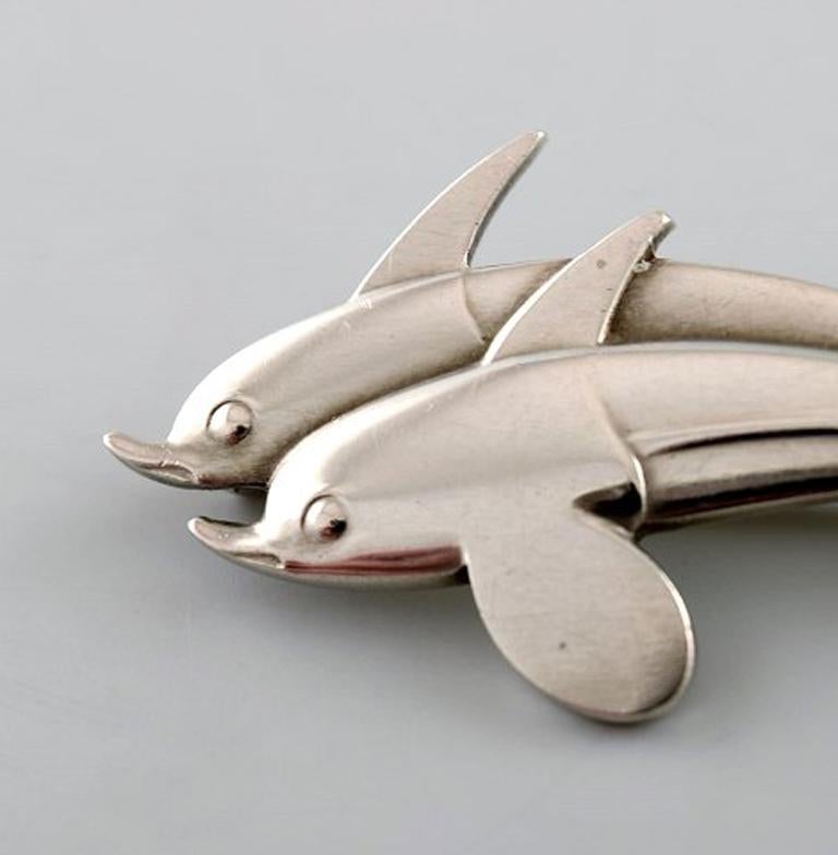 Sterling silver brooch by Georg Jensen. Design number 311. Two dolphins.
Stamped.
In very good condition.
Measures: 4.2 x 1.8 cm.