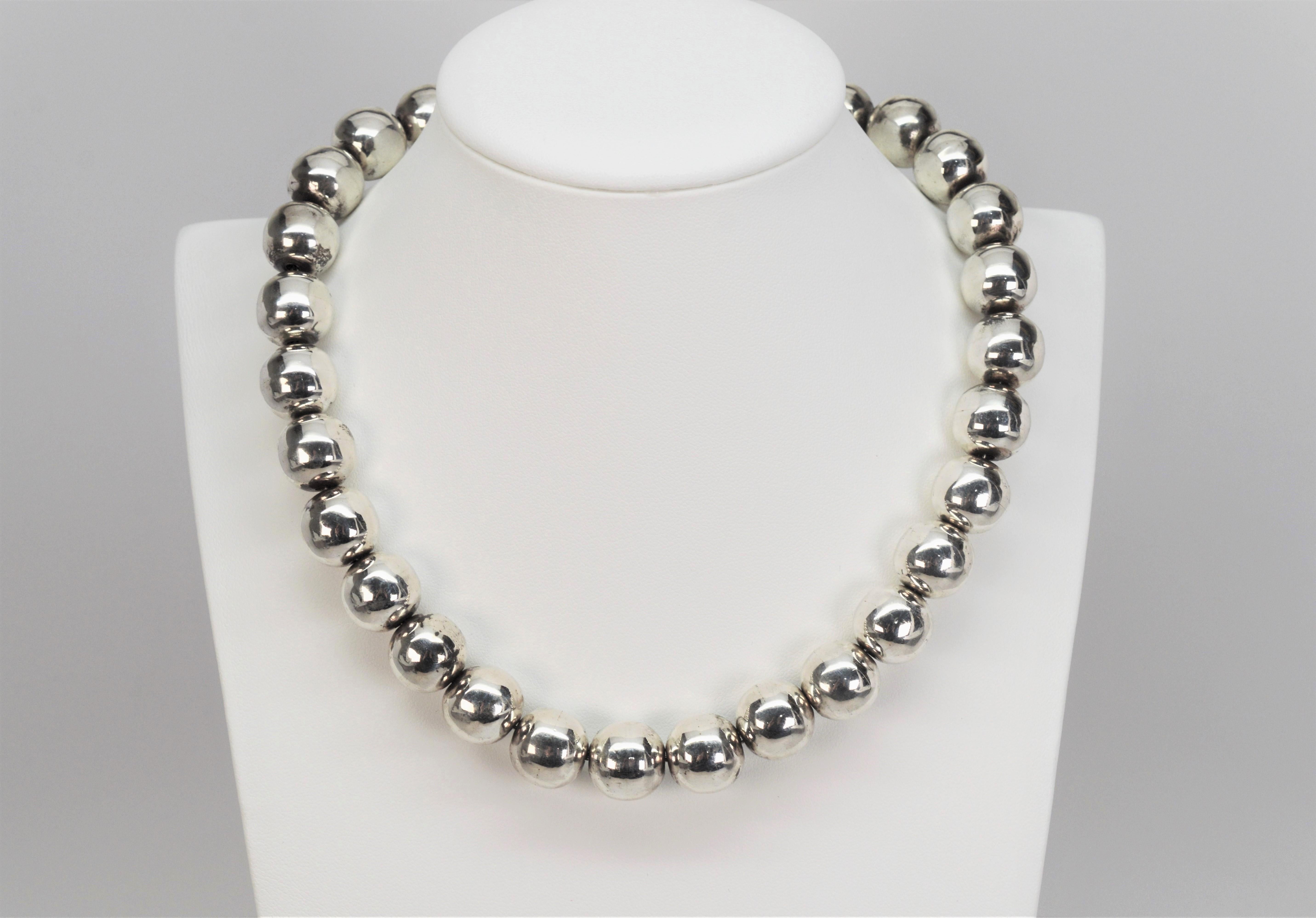 Plump and uniform in shape and size, twenty nine 13.5 mm sterling silver beads create this bright sterling collar necklace. 
Sixteen inches in length and finished with box clasp. Made in Mexico and stamped .925. Gift Boxed. 
