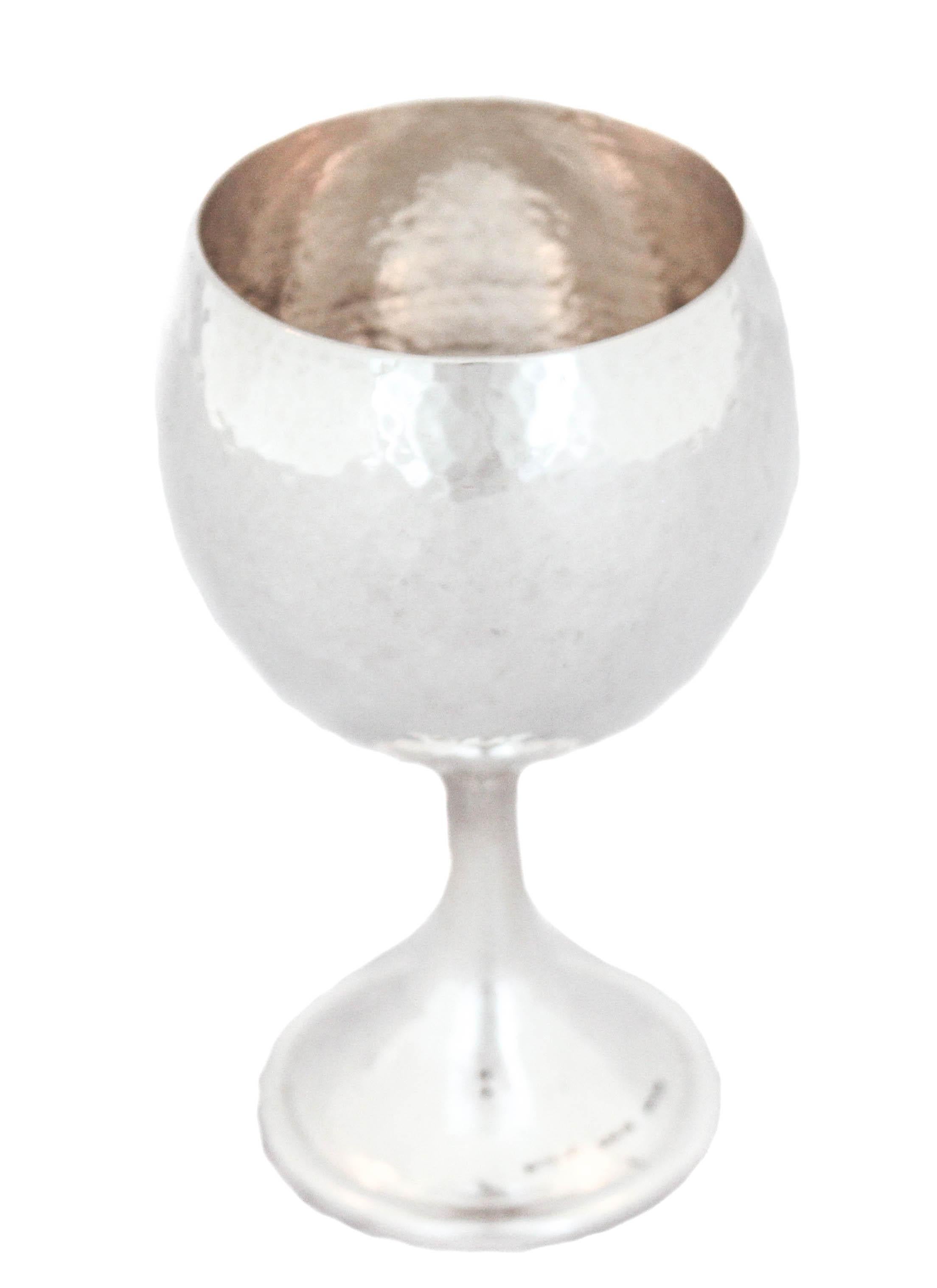 This sterling silver hand hammered goblet is made by and signed “Buccellati Sterling”. It is modern and still elegant. The top portion is rounded and compliments the stem base. A real treasure waiting to grace your table!