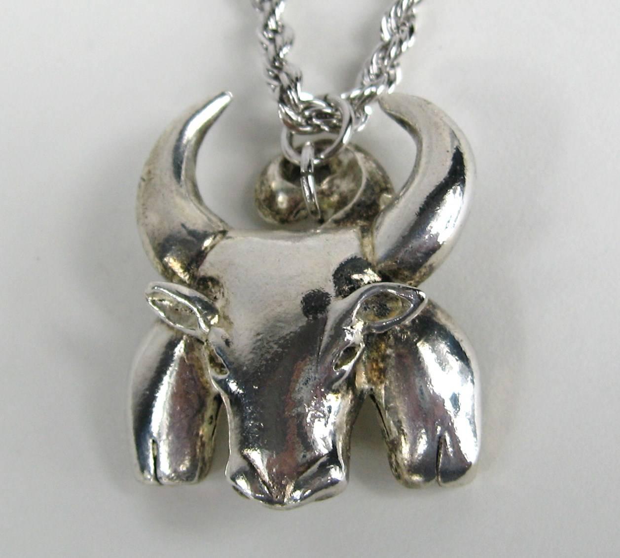 Sterling Silver with a Bulls face pendant hanging on a sterling rope chain. The Necklace is New, Never Worn  from the early 1990s. Measures 1.25 in. wide x 1.40 in. top to bottom -- Chain is 20 inches end to end Matching Bracelet is available on our