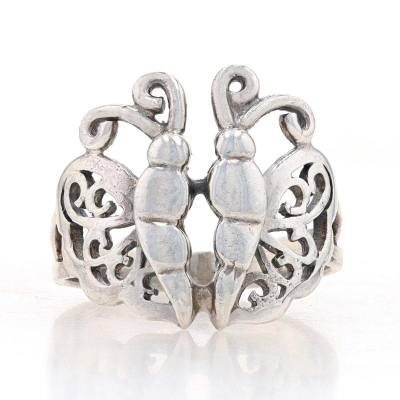 This ring is a size 6 3/4.

Metal Content: Sterling Silver

Style: Statement
Theme: Butterfly, Insect, Nature
Features: Open Cut Scrollwork

Measurements
Face Height (north to south): 11/16