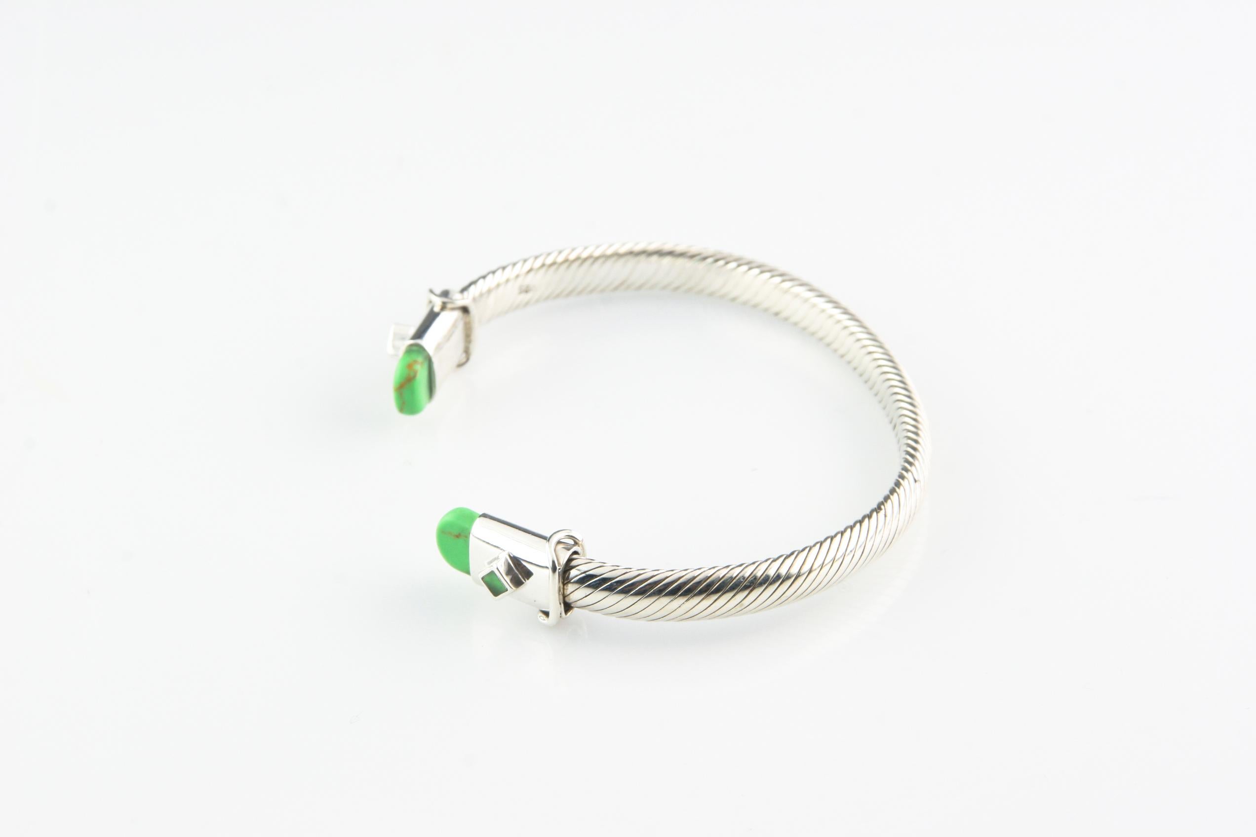 Gorgeous sterling silver cable cuff bracelet.
Ends of the bracelet are capped with green stones.
Wrist Fit: 7 inches.
Outer Circumference: 8.25 inches.
Width: 6 mm.
Weight: 28.7 grams.
Amazing gift for your loved one!